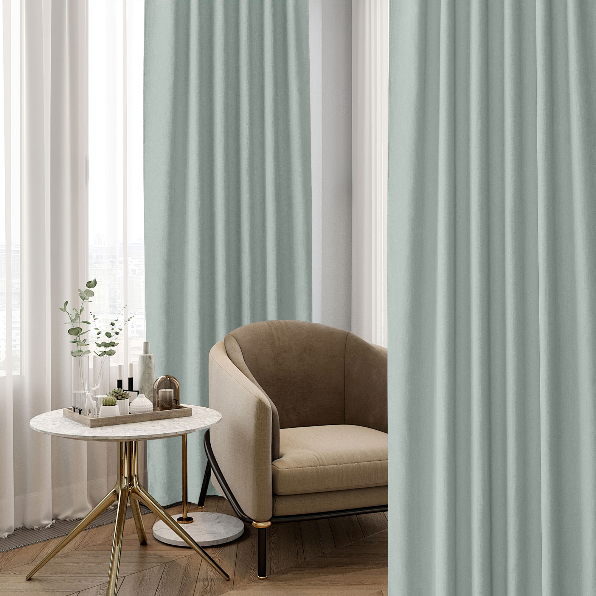 Light sage chenille blackout curtains frame a window next to an elegant armchair and side table, highlighting their luxurious texture.