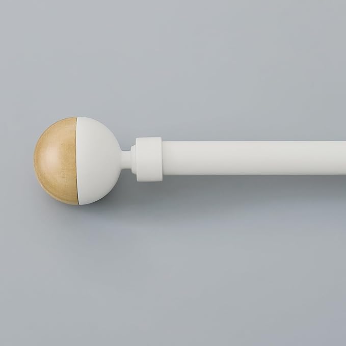 White adjustable curtain rod with a distinctive wood grain and white ball finial, perfect for modern window treatments.