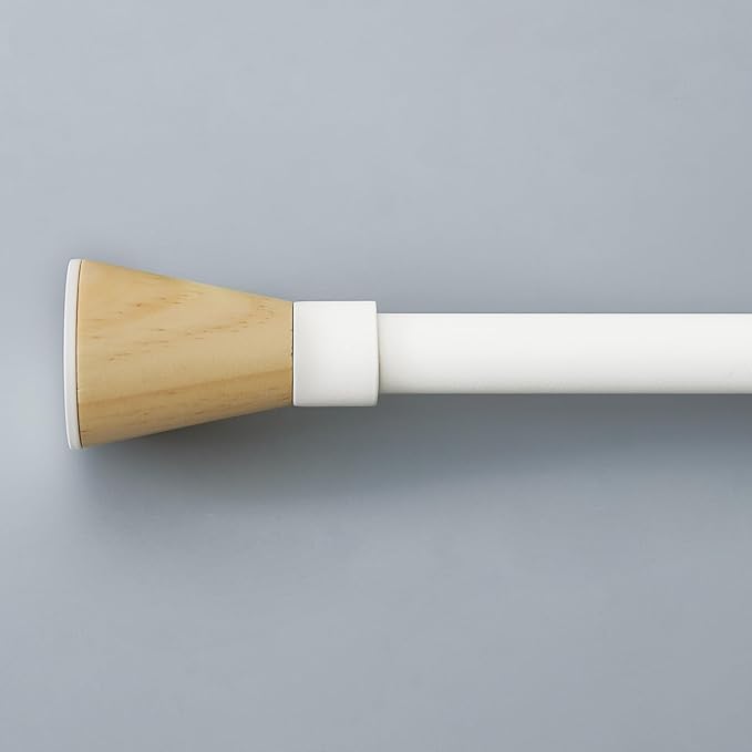 Adjustable white curtain rod with a natural tapered wooden finial, ideal for modern window treatments and room darkening.