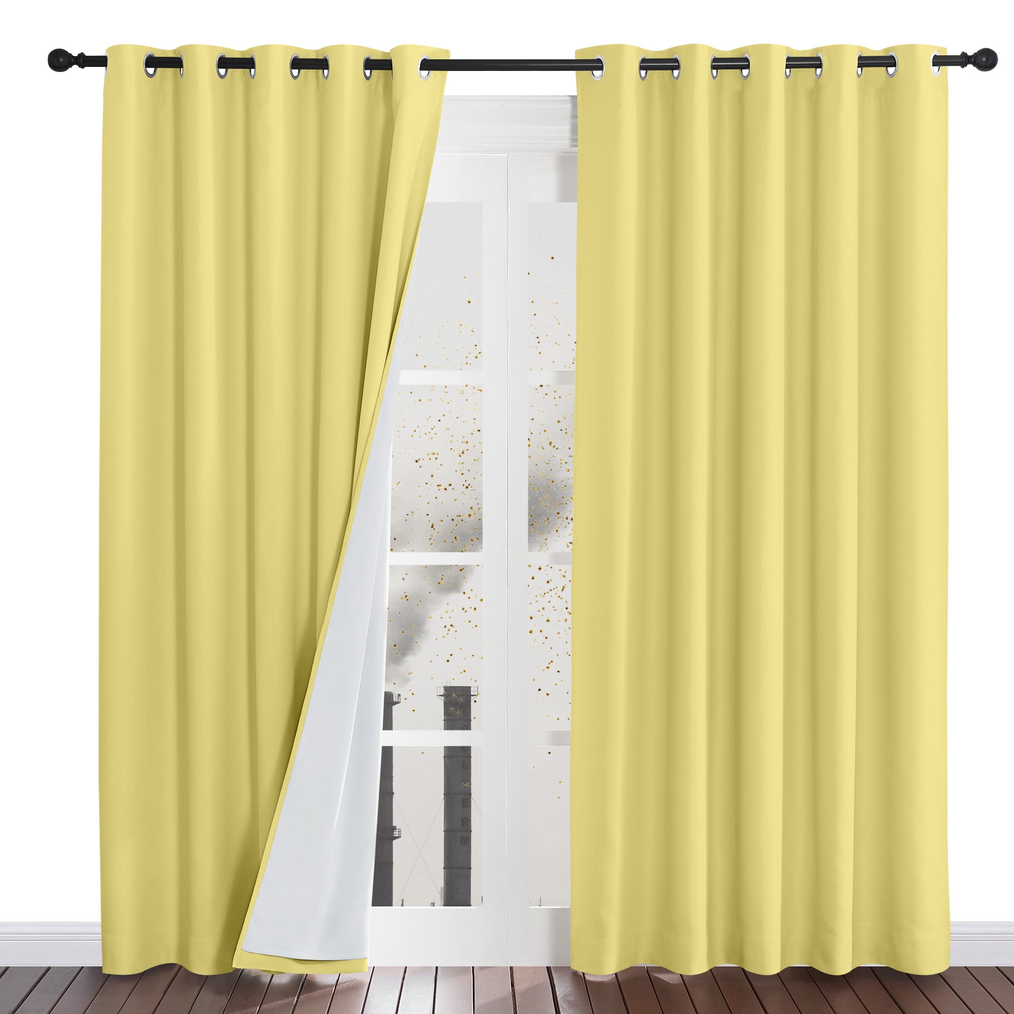 Pale yellow four-layer dustproof curtain pulled back to show its white backing, blocking simulated particles outside a window.