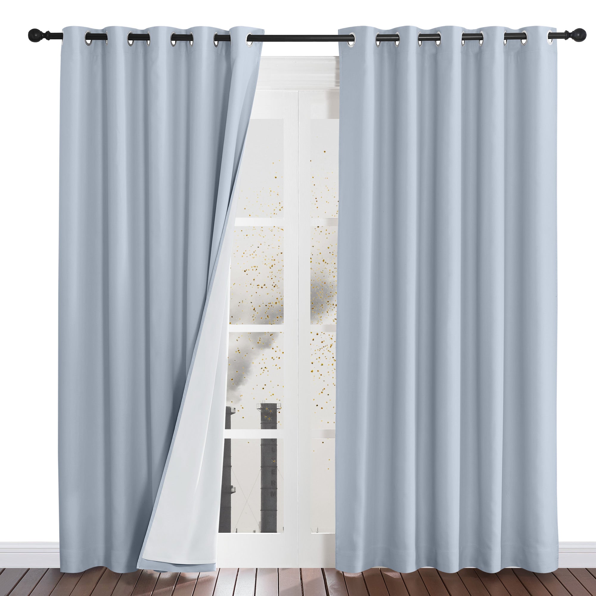 Light blue dustproof curtains protecting a room from pollution, with one panel pulled back to show the white four-layer lining.