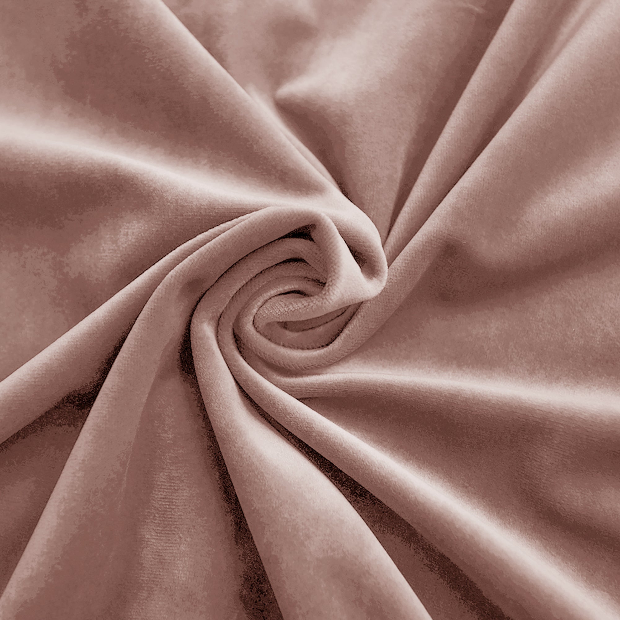 Close-up of plush, swirled rose gold velvet fabric, showcasing its soft texture and elegant sheen.