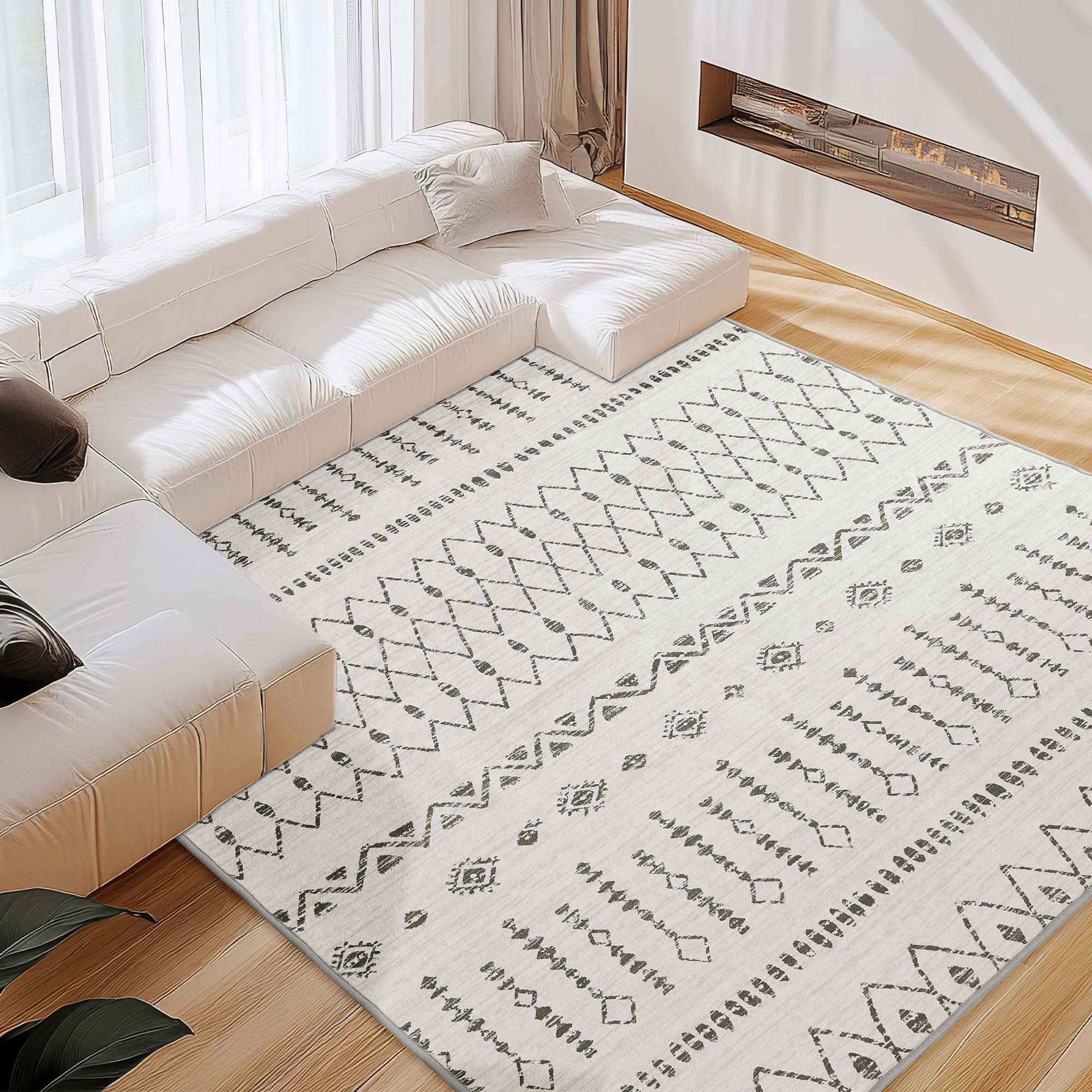 Starry Sand faux wool rug, featuring grey geometric patterns, laid on hardwood floor in a modern living room with a white sectional.