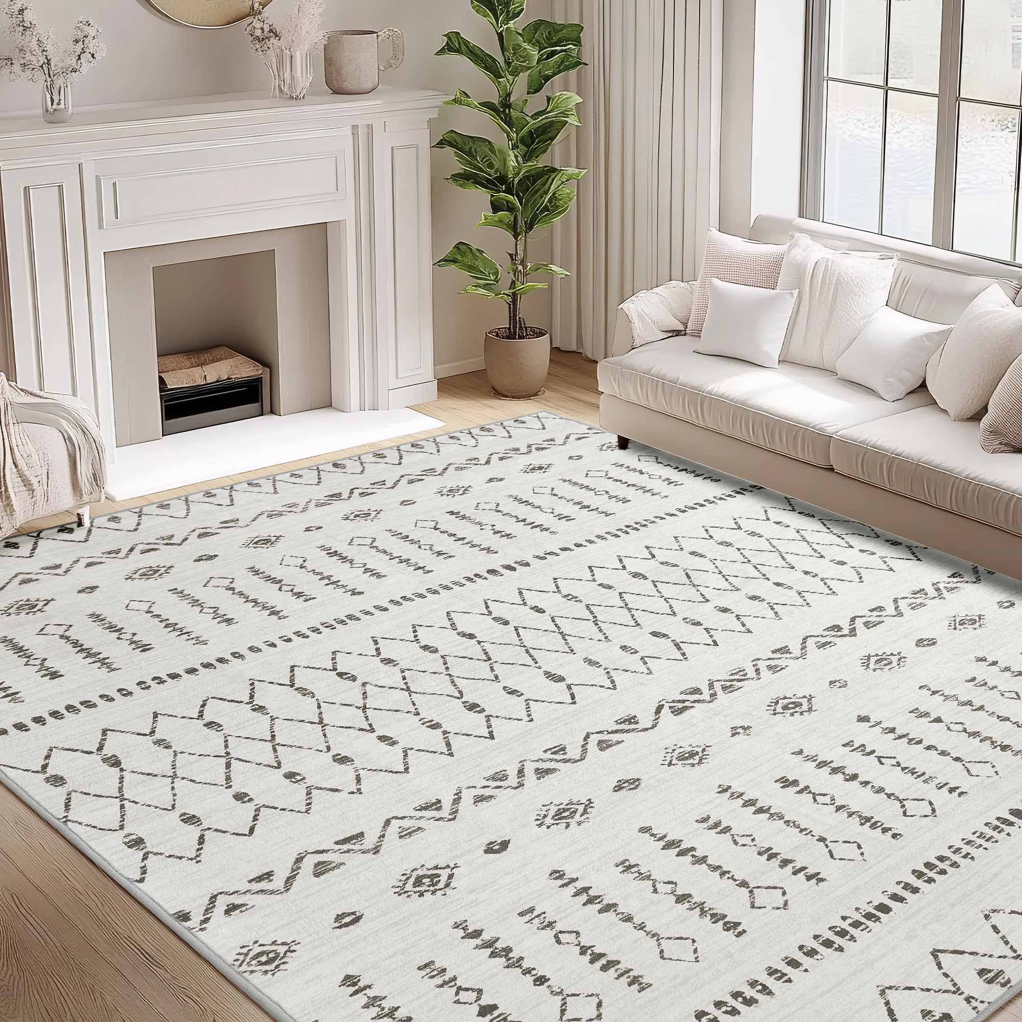 Starry Sand faux wool rug with cream base and dark gray geometric patterns in a cozy living room, complemented by a sofa and fireplace.