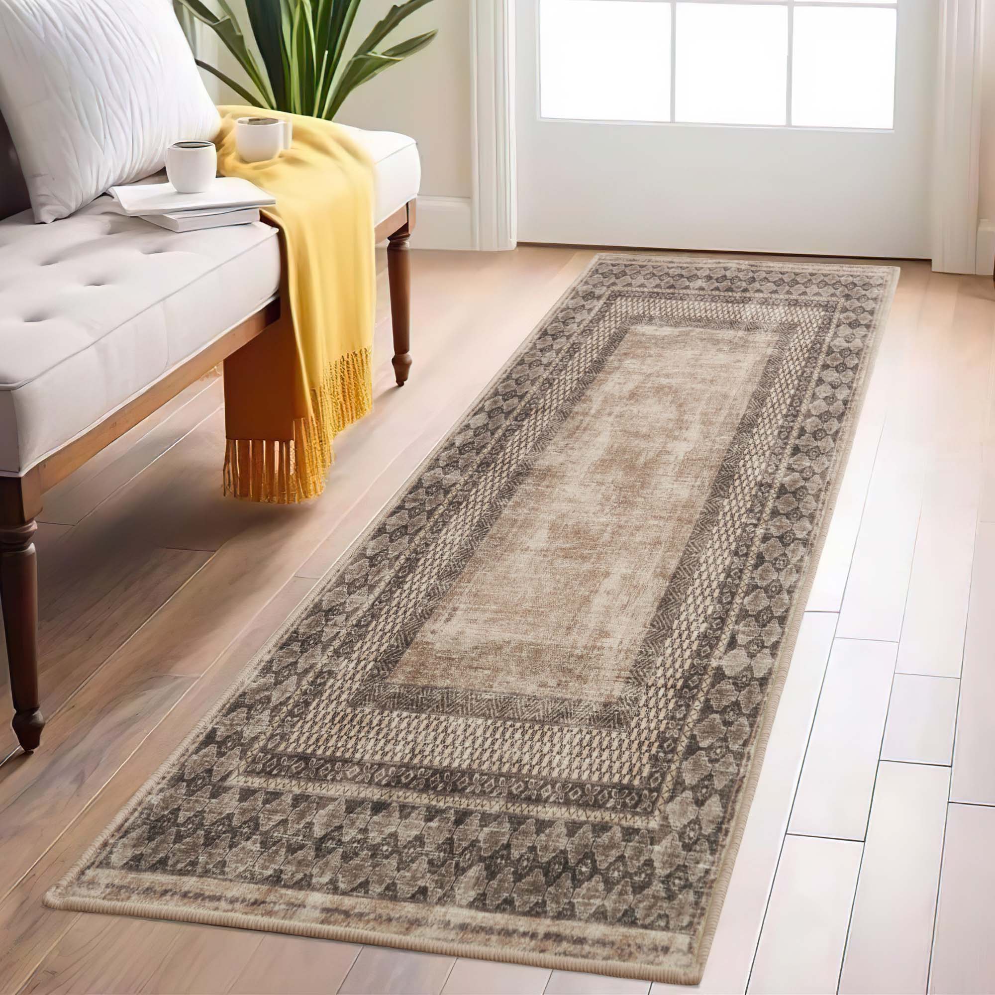 Tribal Realm faux wool runner rug in distressed beige & brown, with intricate patterns, on light wood flooring beside a white bench.