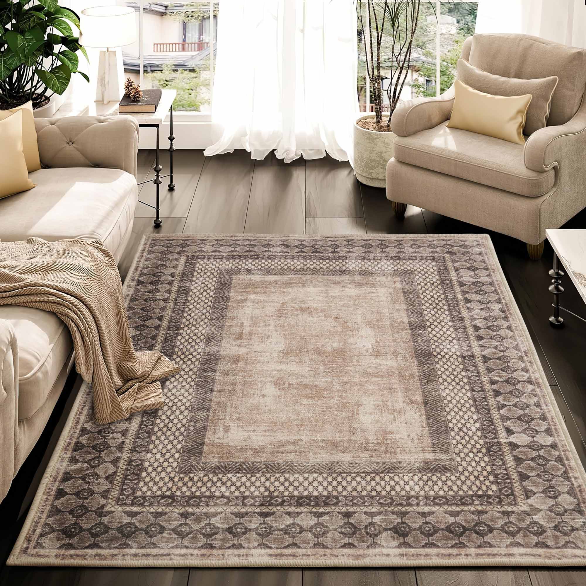 Light beige and grey Tribal Realm faux wool rug with intricate tribal borders on dark wood floor, styled in a living room.