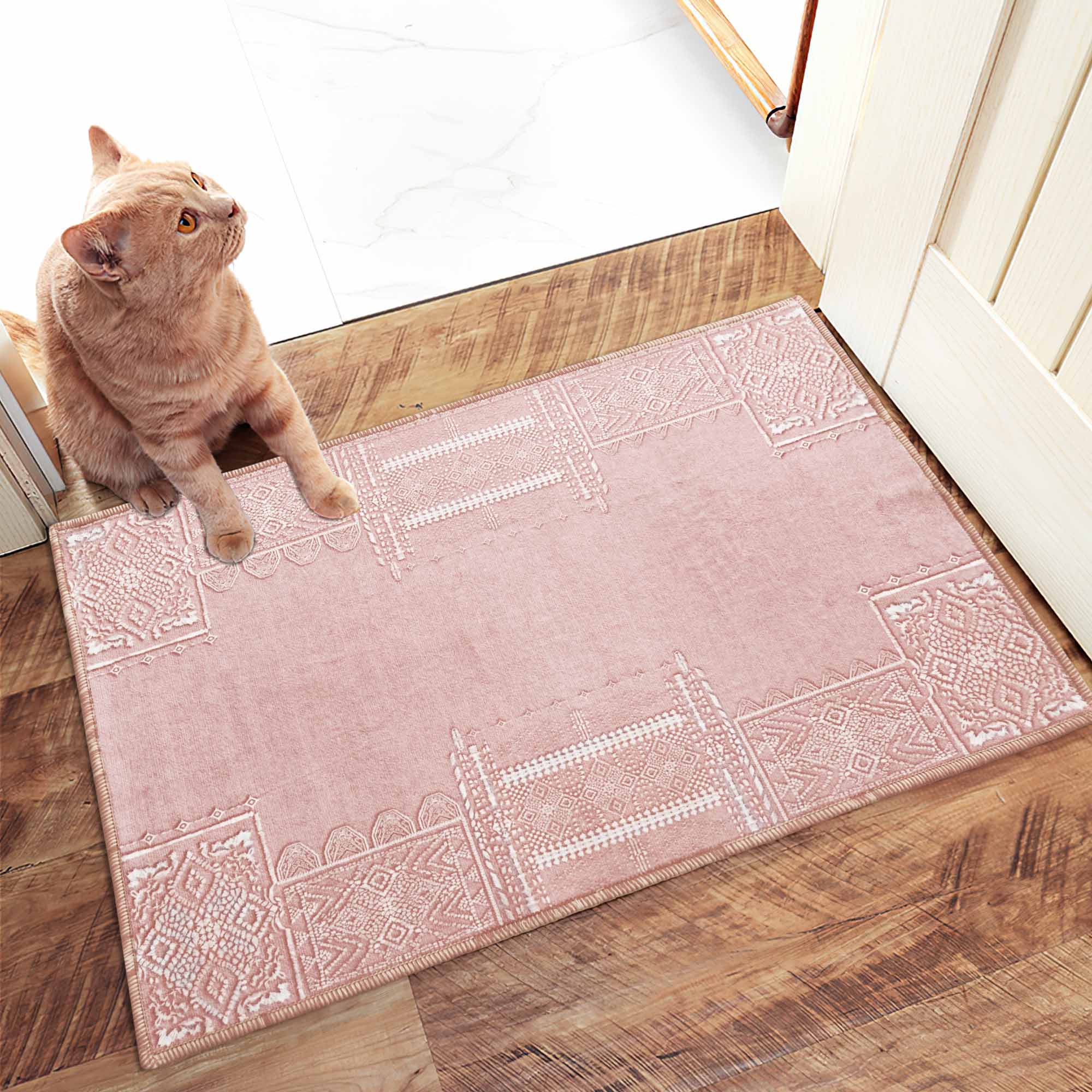 Soft pink Faux Wool Rug with detailed white geometric 'Dream of Mobius' patterns, an orange cat sits on it looking up.