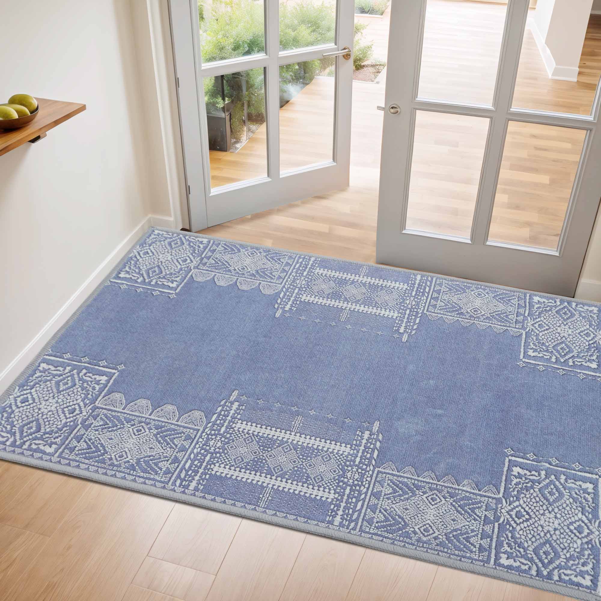 Blue Faux Wool Rug - The Dream of Mobius with intricate white geometric patterns on a wooden floor in an entryway.