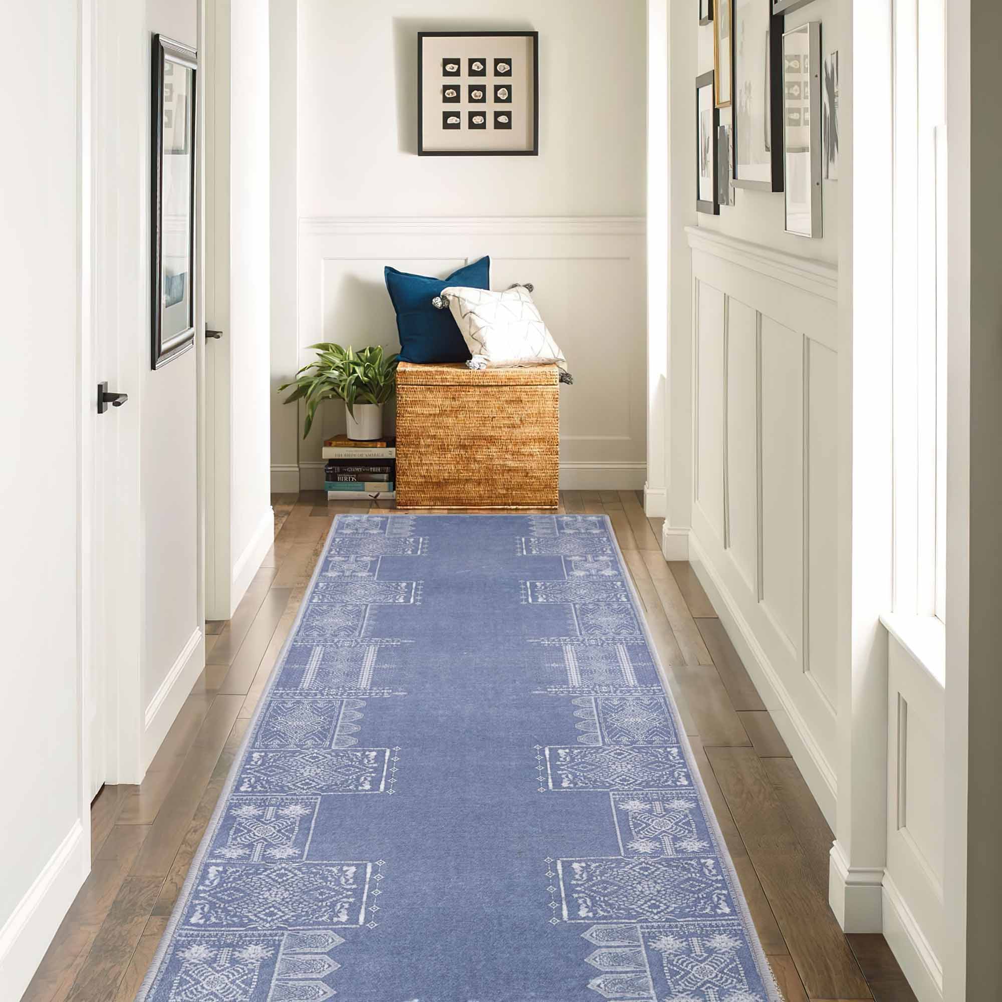 Blue faux wool runner rug, 'The Dream of Mobius', featuring white geometric patterns on a hardwood floor hallway.
