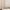 A close-up view of the detailed flat seam at the hem of a light-filtering faux linen sheer curtain.