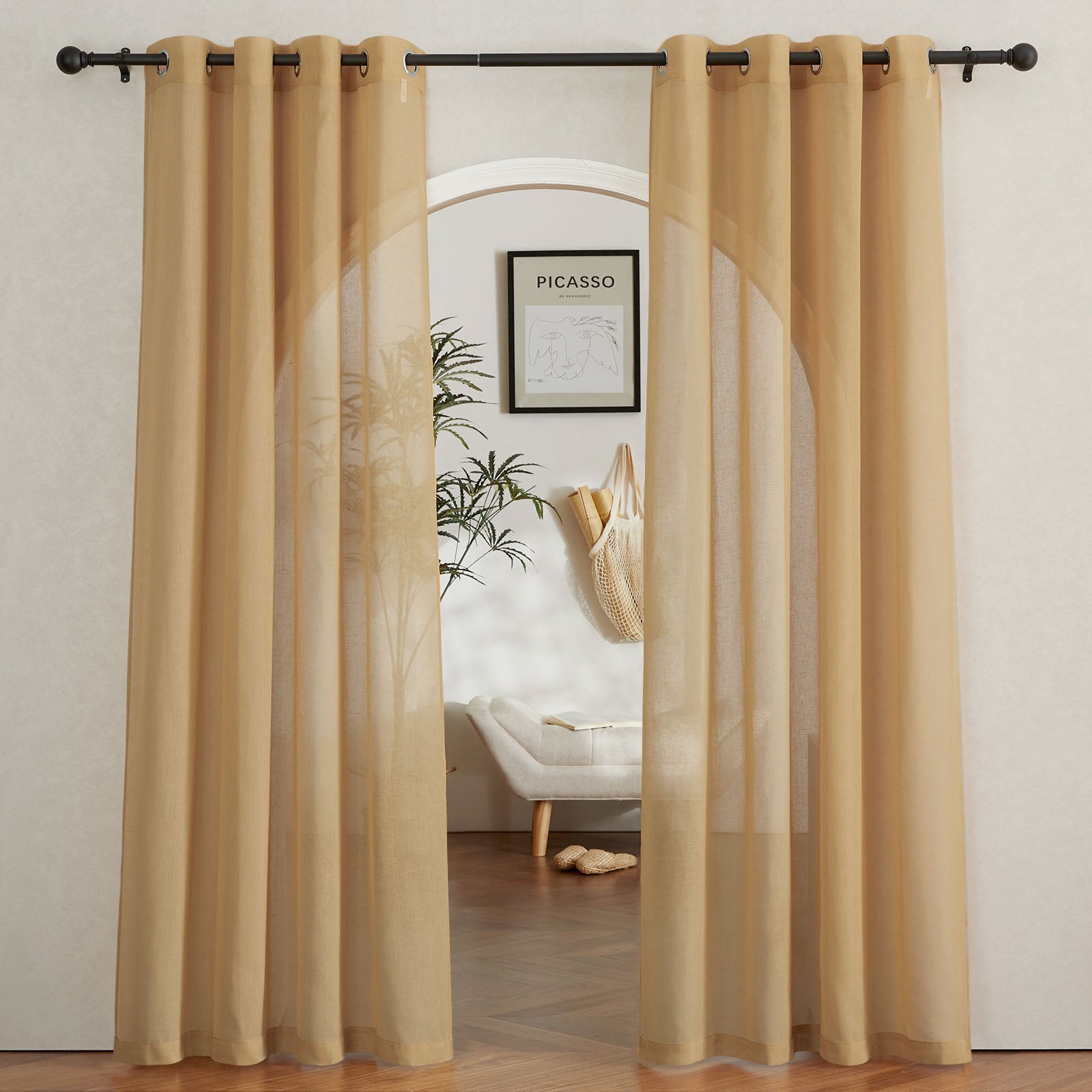 Beige faux linen sheer curtains with grommets on a rod, framing an arched doorway and gently filtering light into the room.