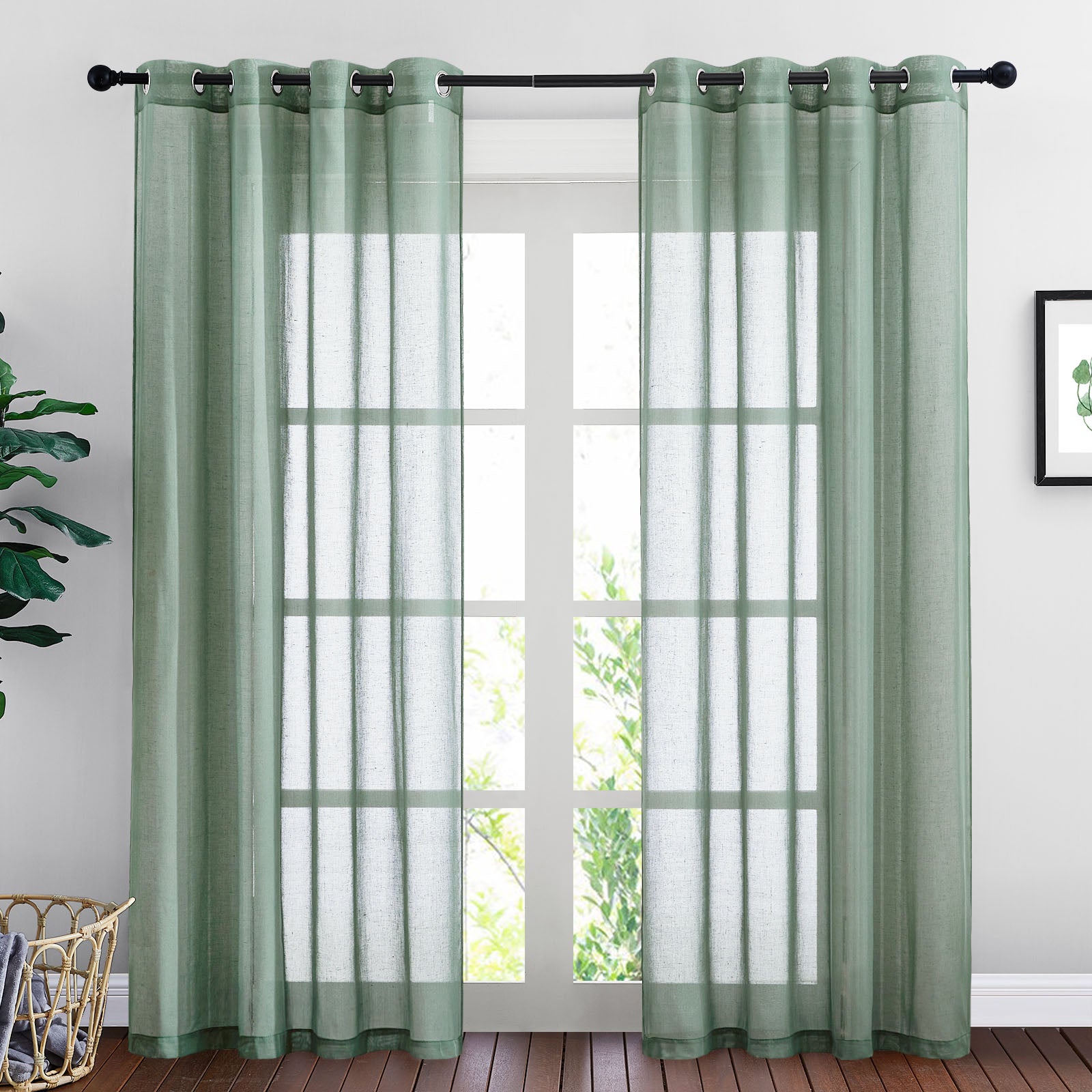 Light green faux linen sheer curtains with metal grommets hanging on a black rod, filtering light over a large window.