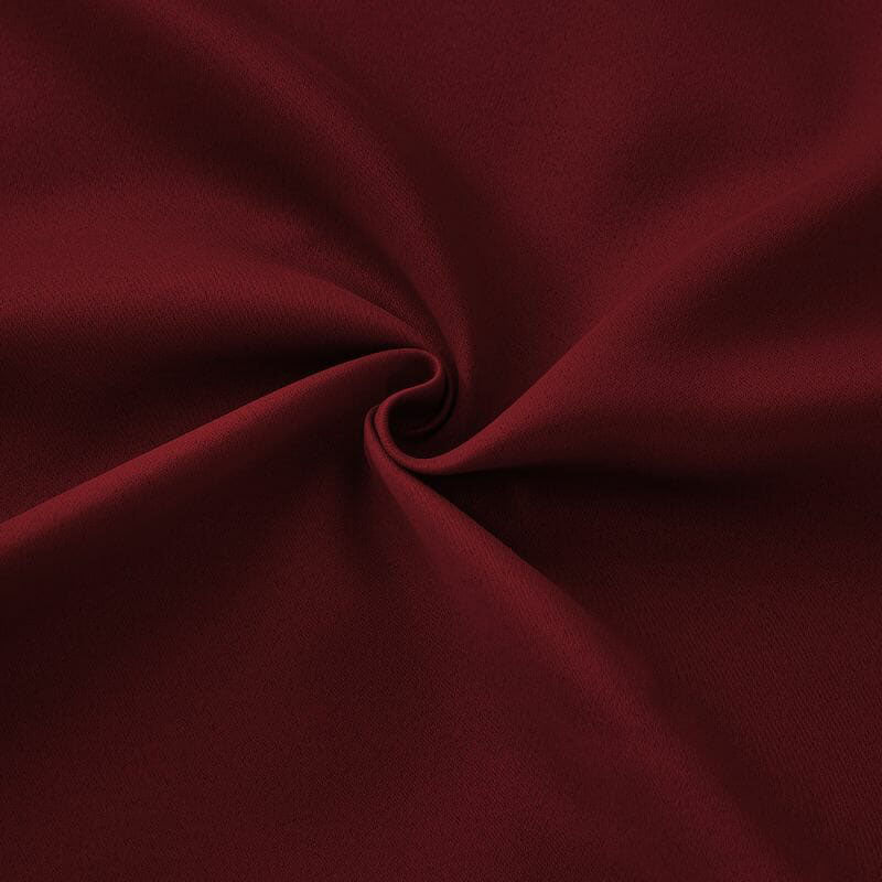 Close-up of deep red flame retardant curtain fabric, showcasing its fine weave, plush texture, and a soft swirl.