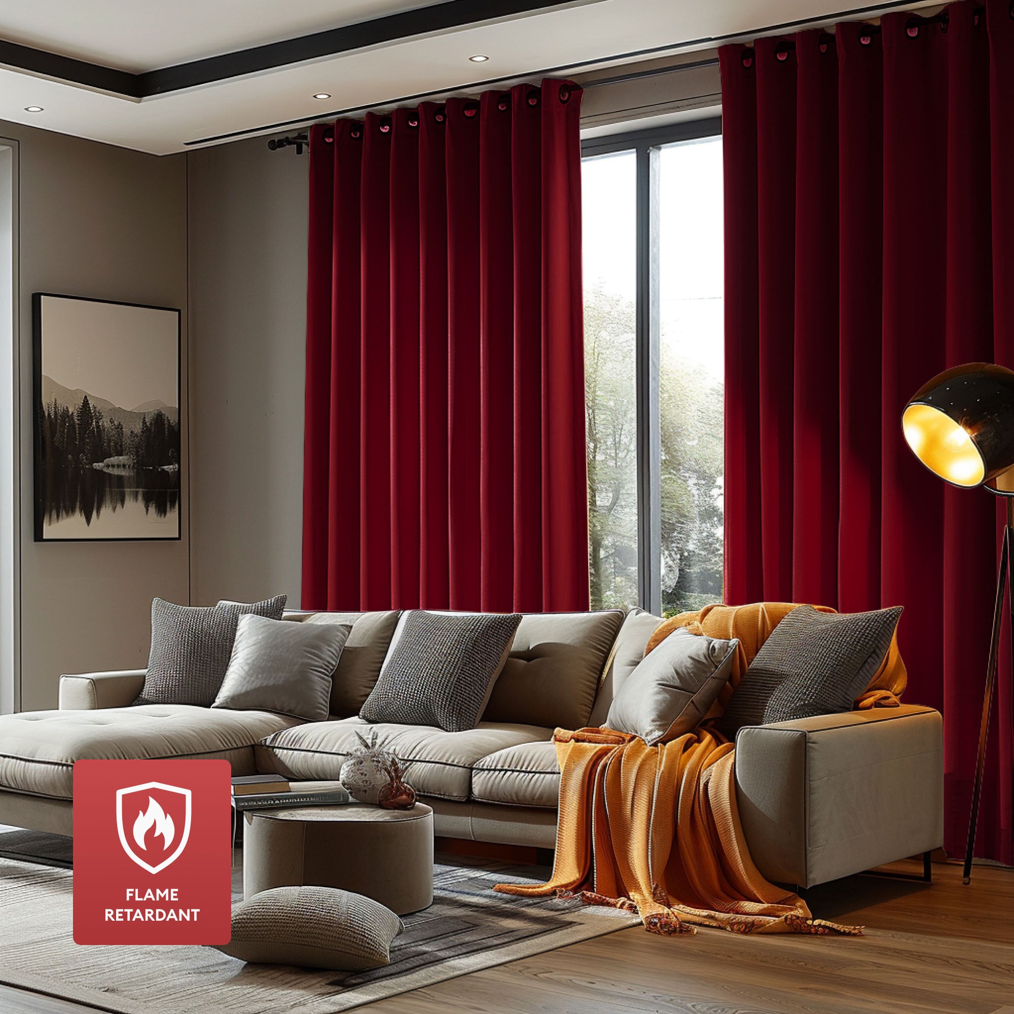 Elegant dark red flame retardant grommet curtains covering a large window in a modern living room with a neutral sectional sofa.