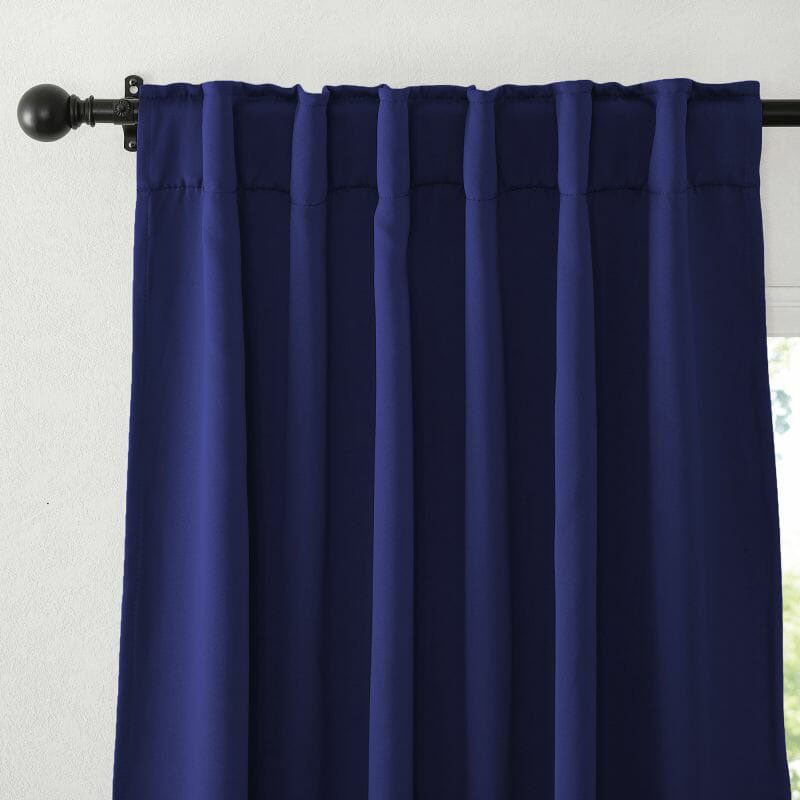 Dark blue flame retardant curtain featuring a rod pocket header, neatly hanging from a black rod, highlighting the fabric's rich texture.