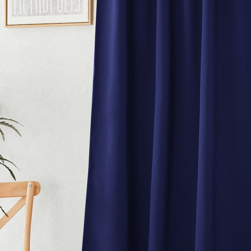 Close-up of a deep navy blue flame retardant curtain, highlighting its smooth fabric texture and elegant vertical pleats.