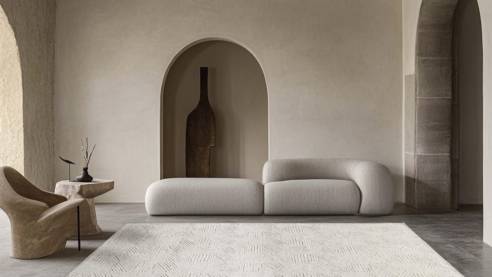 Light beige Jacquard Chenille Area Rug with subtle hexagon pattern in a minimalist living room setting, featuring a curved sofa.