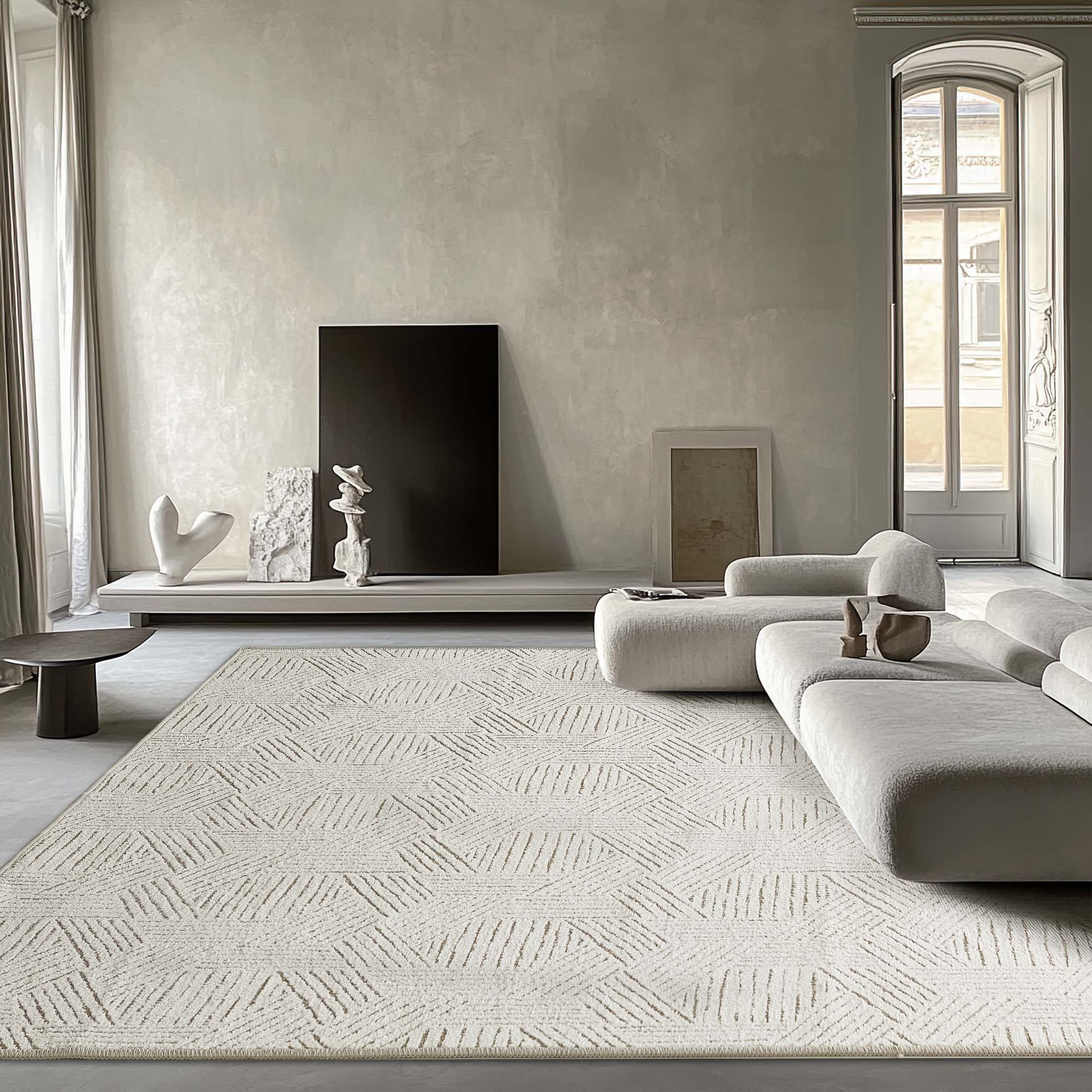 Full view of a light Jacquard Chenille area rug with raised abstract geometric pattern, complementing a modern living room setting.
