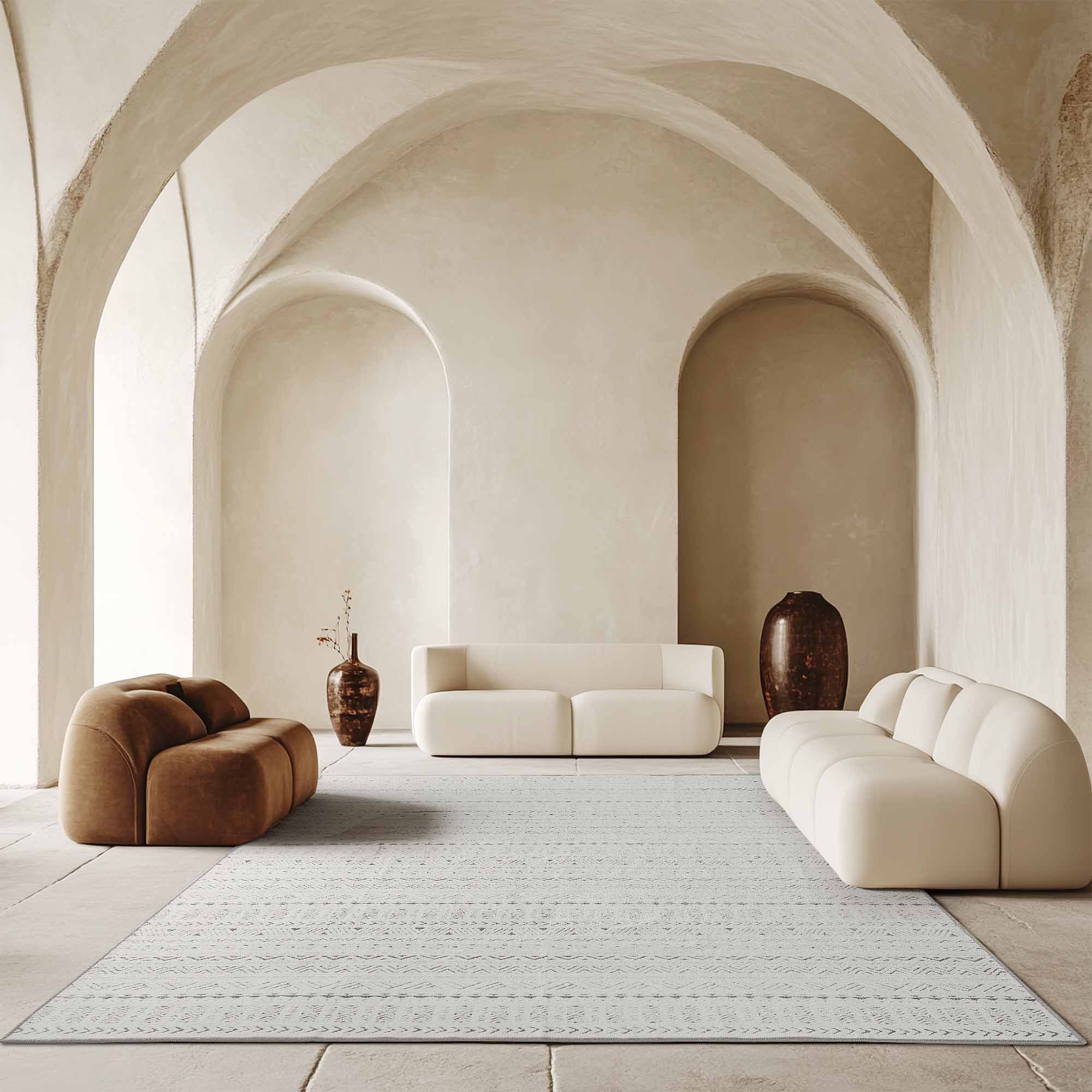 Light grey Tubekale Moroccan Jacquard Chenille Area Rug with intricate geometric patterns in a chic arched living room.
