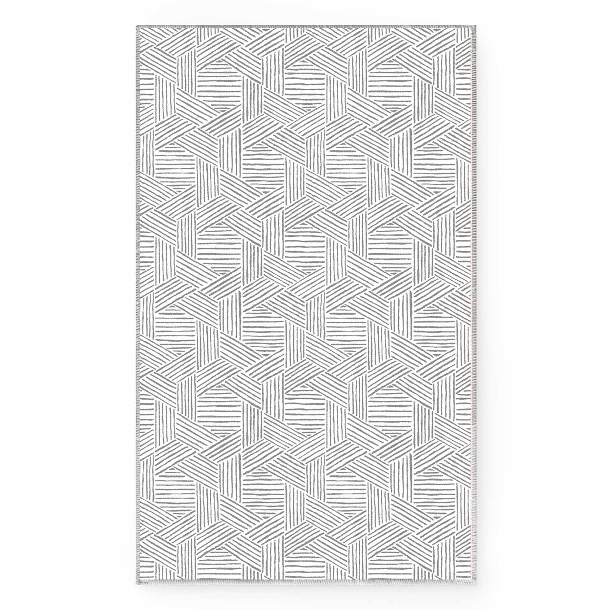 Full view of the gray and white Jacquard Chenille area rug, showcasing its modern geometric hexagon pattern of hatched lines.
