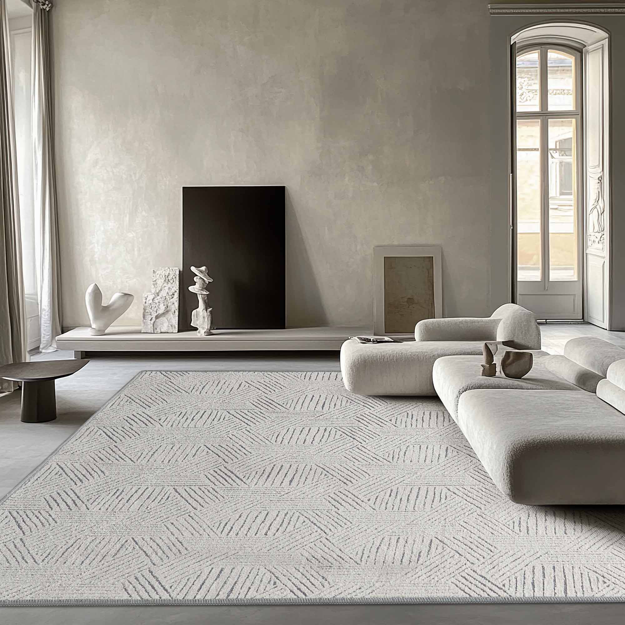 Large light grey Jacquard Chenille area rug with an abstract geometric hexagon pattern, anchoring a modern minimalist living room.