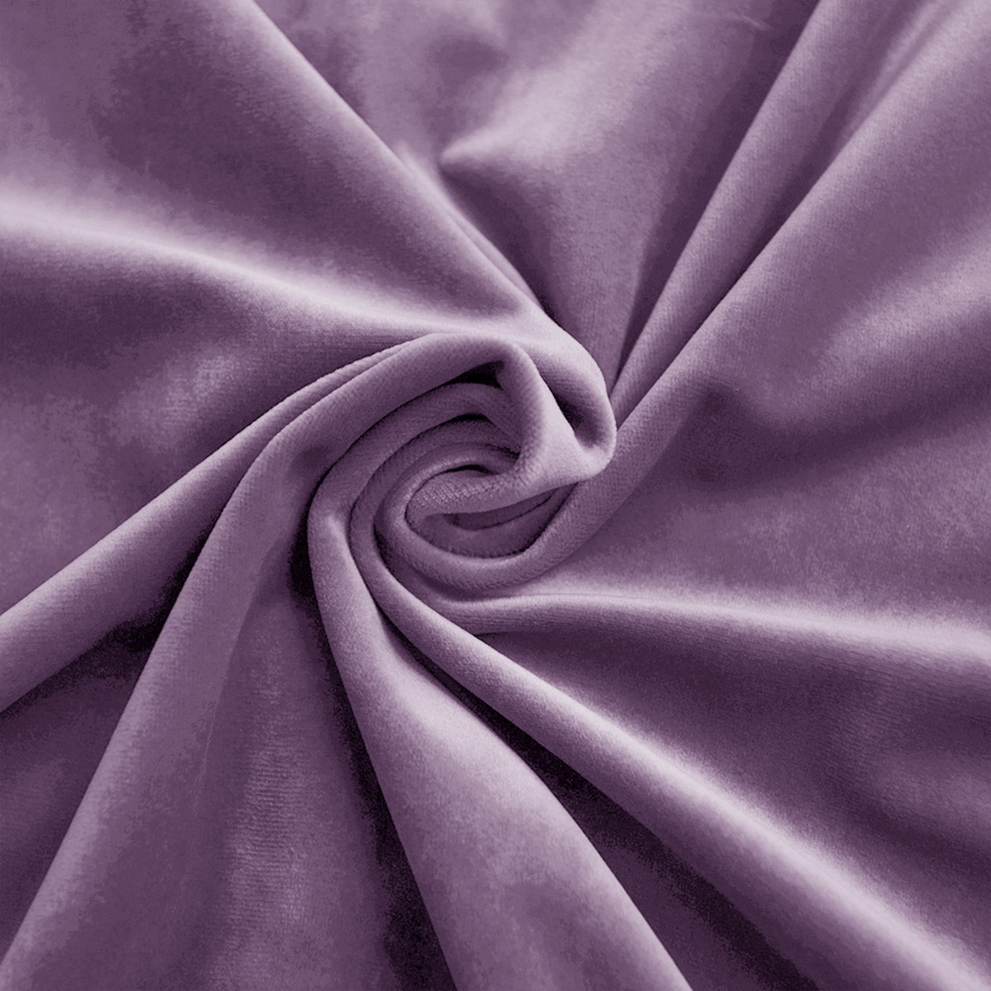 Close-up of soft purple velvet fabric swirled, showcasing its luxurious texture and subtle sheen from folds.