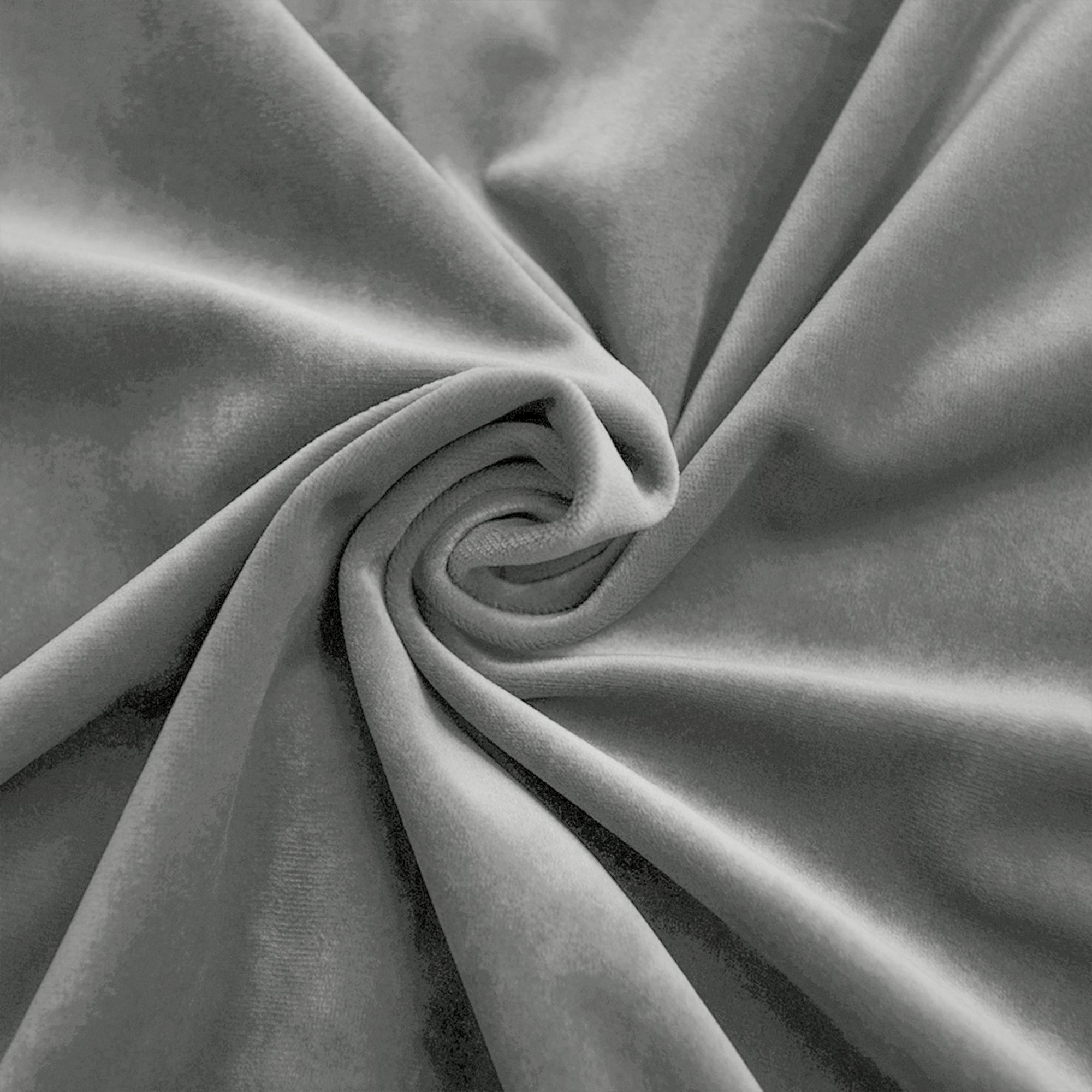 Close-up of a grey velvet fabric swatch swirled to show its soft, plush texture and elegant sheen.