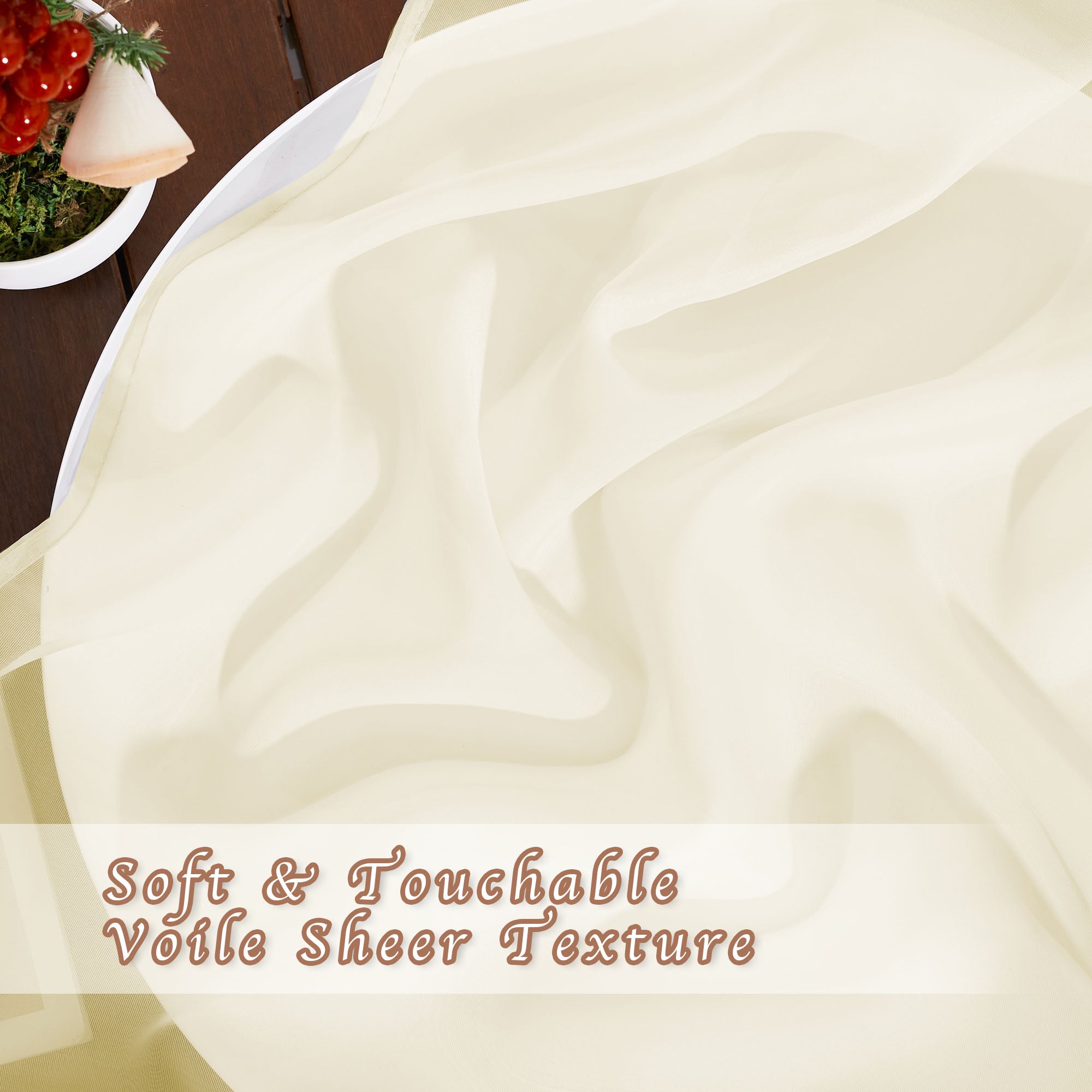 Close-up on the soft, touchable voile texture of a light cream-colored sheer curtain draped on a surface.