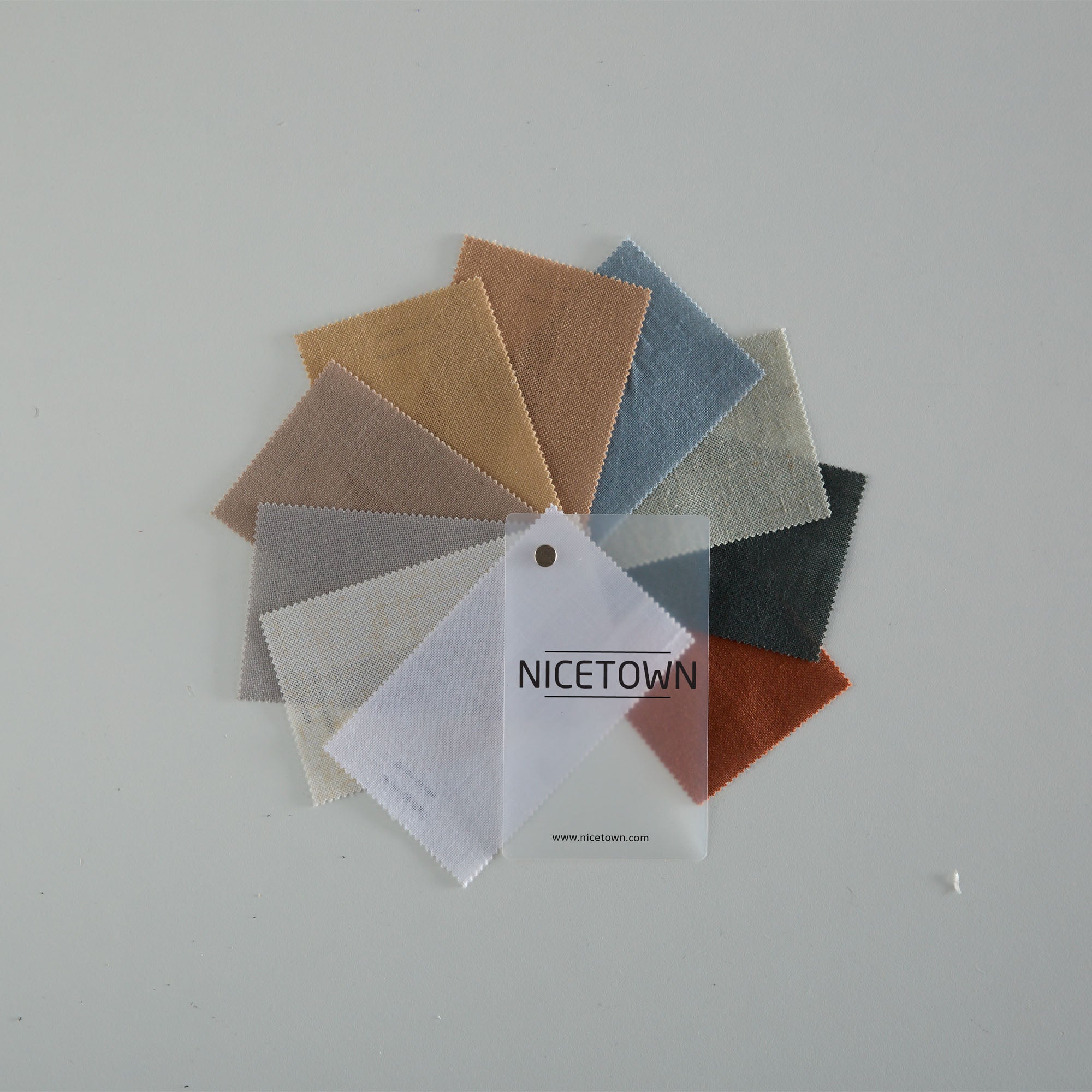 NICETOWN linen fabric swatches fanned out, showcasing diverse textures and colors for custom curtains.