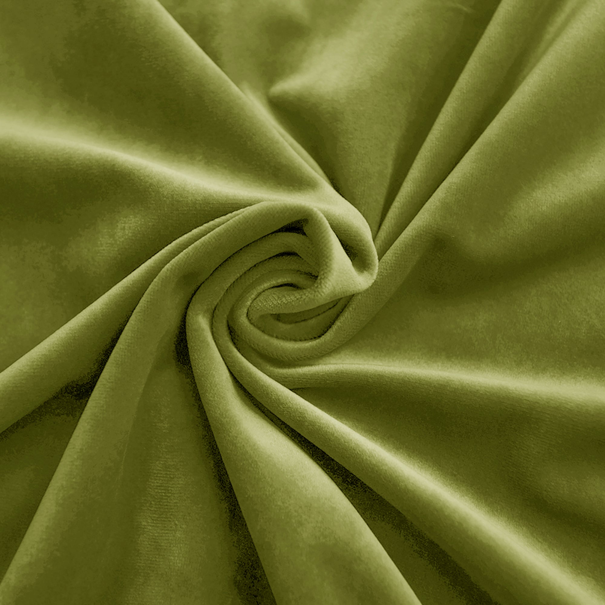 Textured close-up of rich green velvet fabric, showing its soft pile, luxurious sheen, and elegant drape in swirled folds.