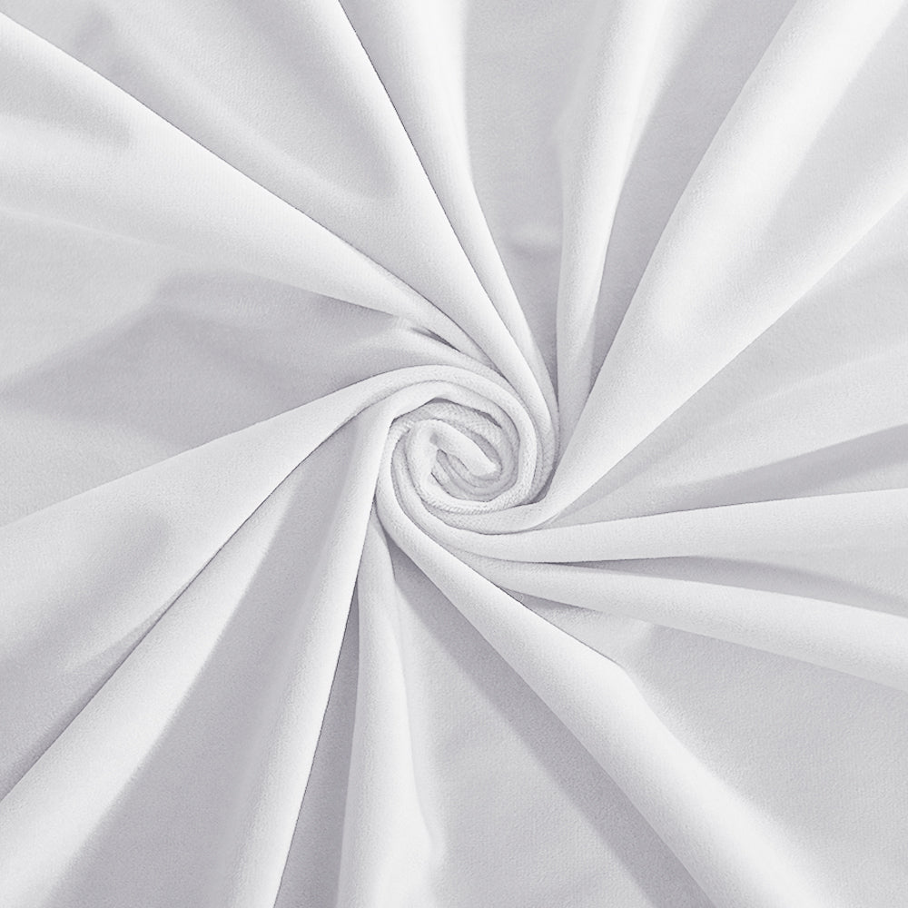 Close-up of a white velvet fabric swatch, draped and swirled to showcase its soft, luxurious texture and slight sheen.