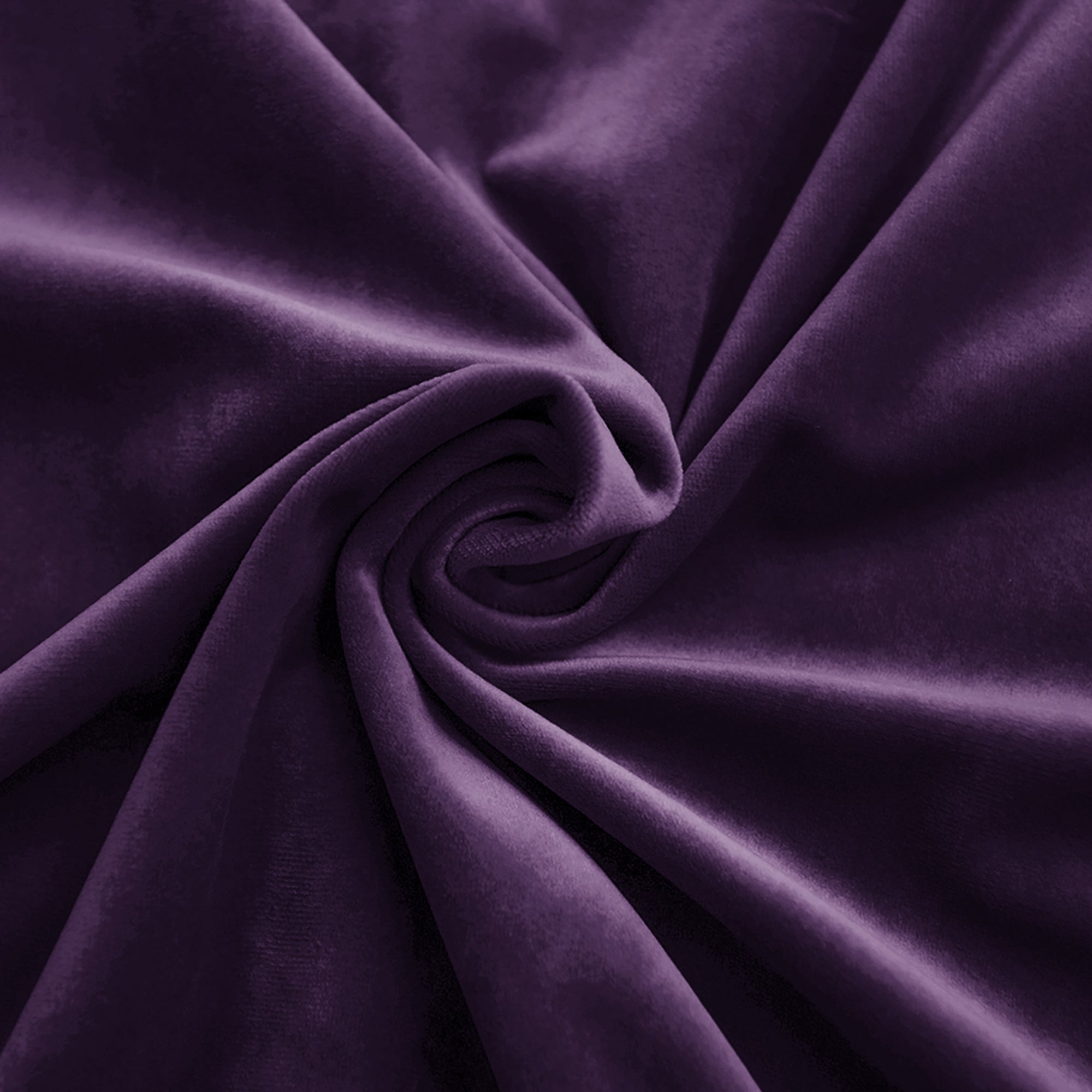 Dark purple velvet fabric draped in soft folds, highlighting its rich color, plush texture, and elegant sheen.