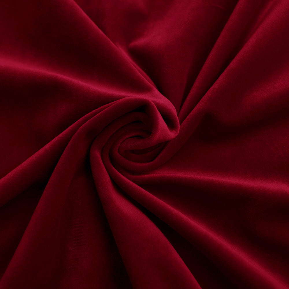 Close-up of a dark red velvet fabric swatch, richly textured and softly draped, highlighting its luxurious pile.