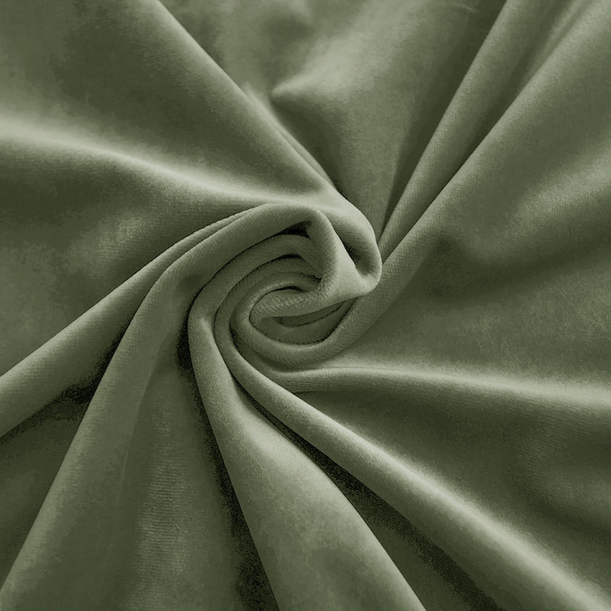 Close-up of olive green velvet fabric swirled to show its soft, plush texture and subtle sheen.