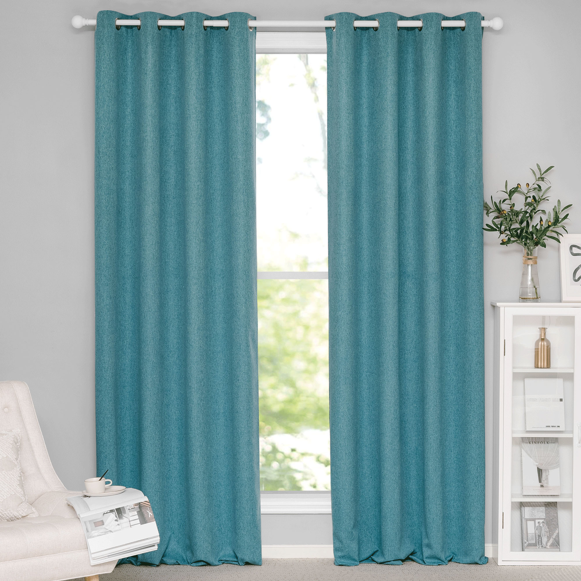Teal soft cotton linen grommet top curtains installed on a white rod, partially covering a sunlit window. The texture is clearly visible.