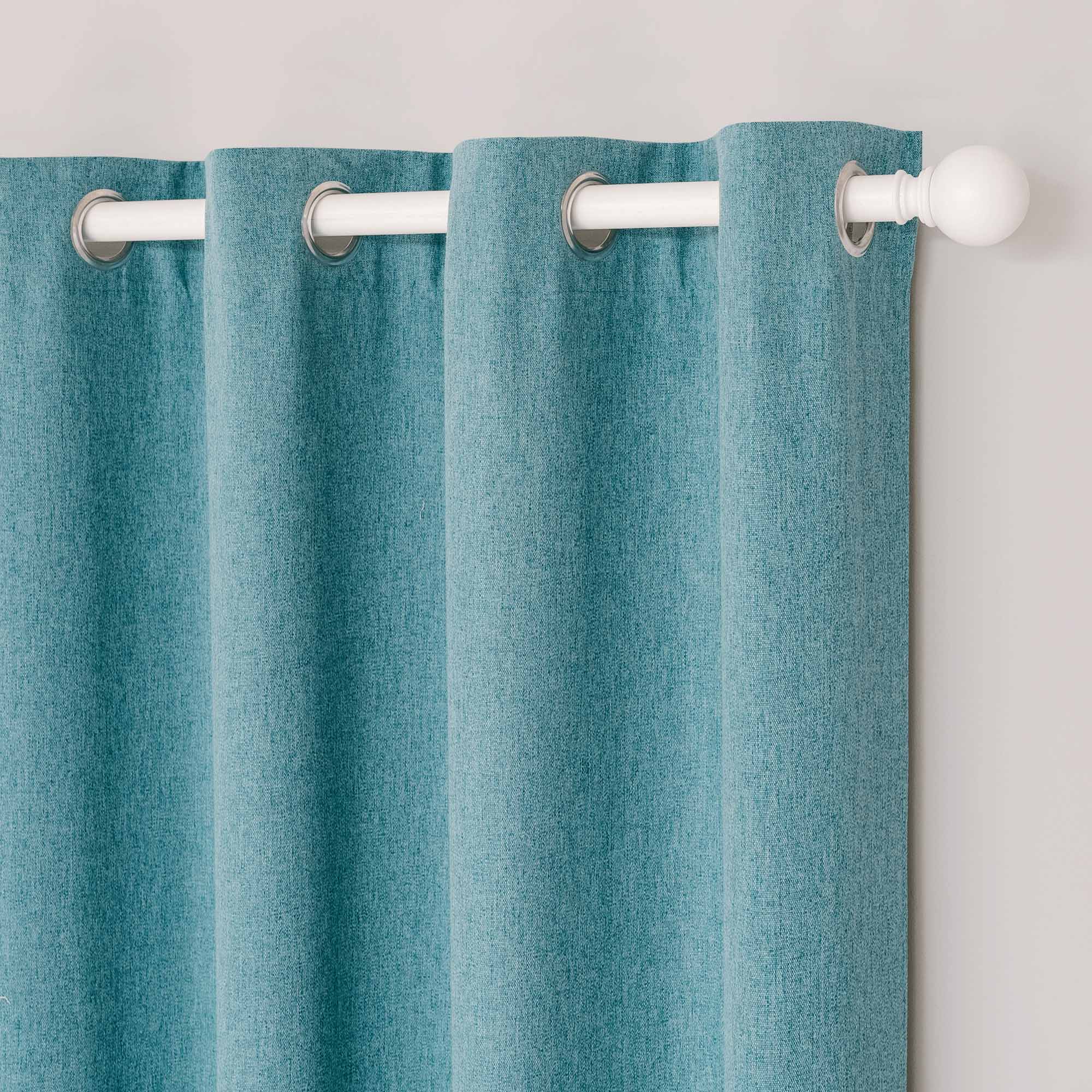 Close-up of soft teal cotton linen curtain with silver grommets on a white rod, showing subtle fabric texture.