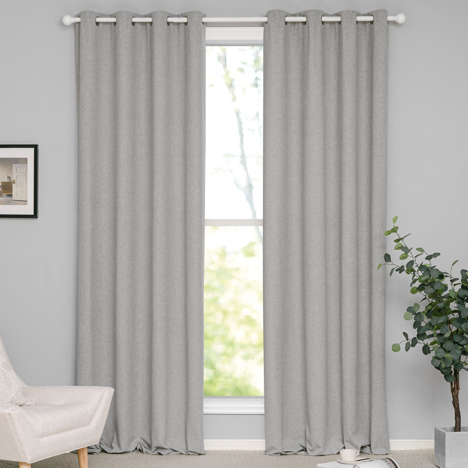 Textured light gray cotton linen grommet curtains on a white rod, partially open to reveal a bright window.
