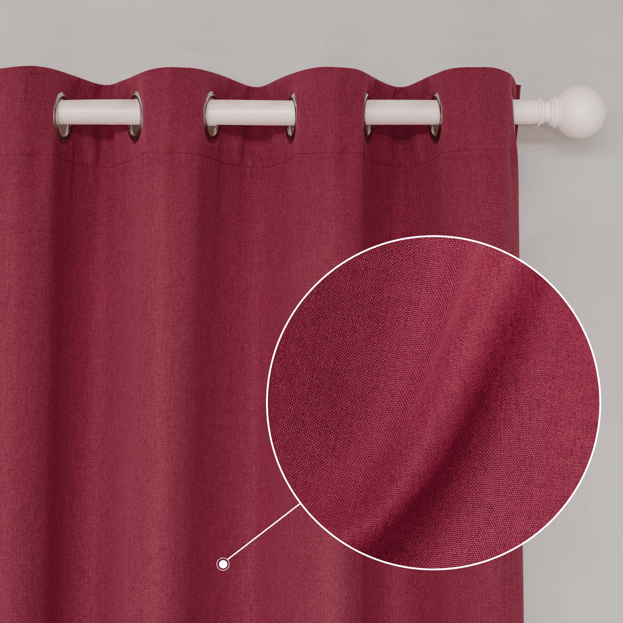 Close-up of a red soft cotton linen curtain with silver grommet top, highlighting the fabric texture and white rod.
