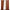 Rust brown 100% blackout curtains with grommet tops on a black rod, partially open to show a window.