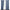 Pair of blue Sound Barrier 100% blackout grommet curtains on a rod, slightly open, revealing a sunlit window.