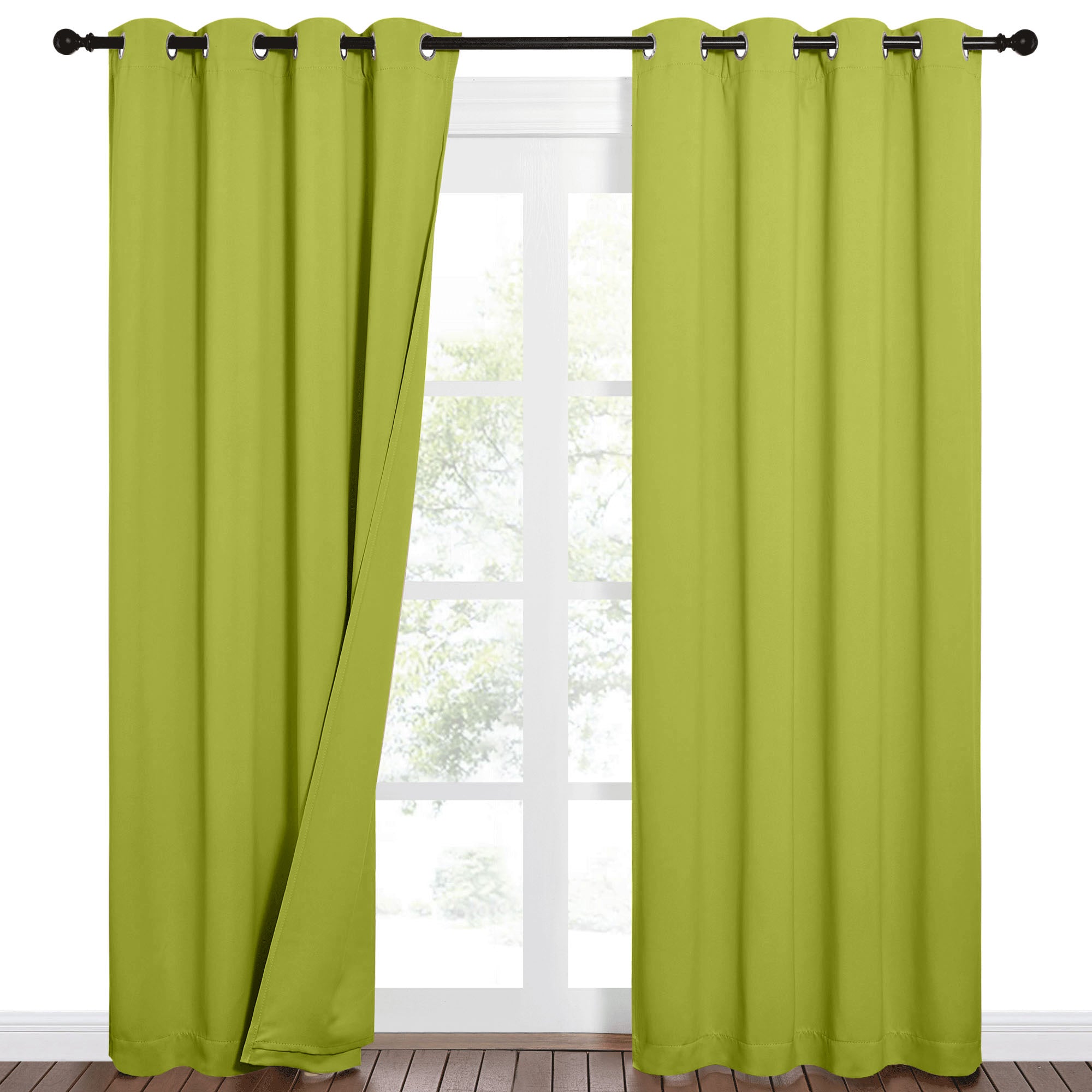 Pair of lime green grommet blackout curtains on a dark rod, one pulled slightly open to show a bright window and outdoor view.