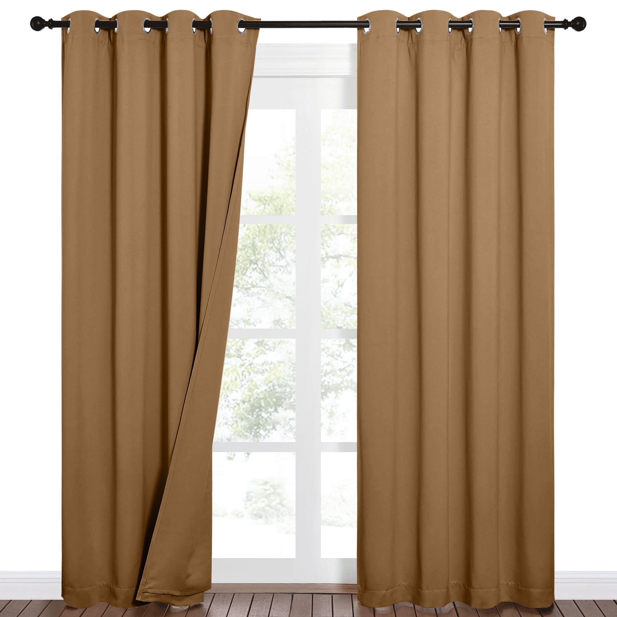 Brown sound barrier 100% blackout grommet curtains on a black rod. One panel slightly open reveals a bright window.