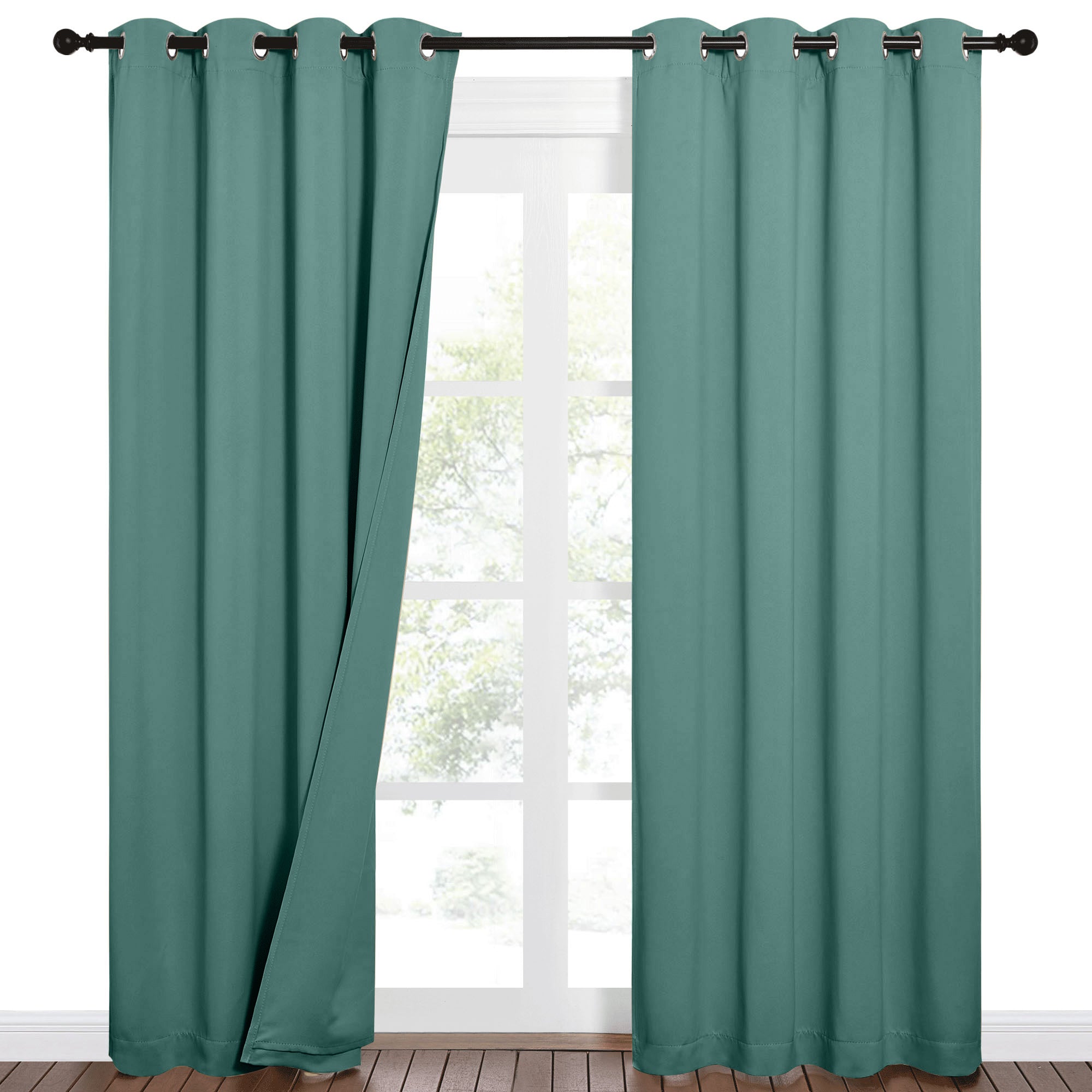 Teal grommet blackout curtains on a rod, one panel slightly open showing a bright window with trees outside.