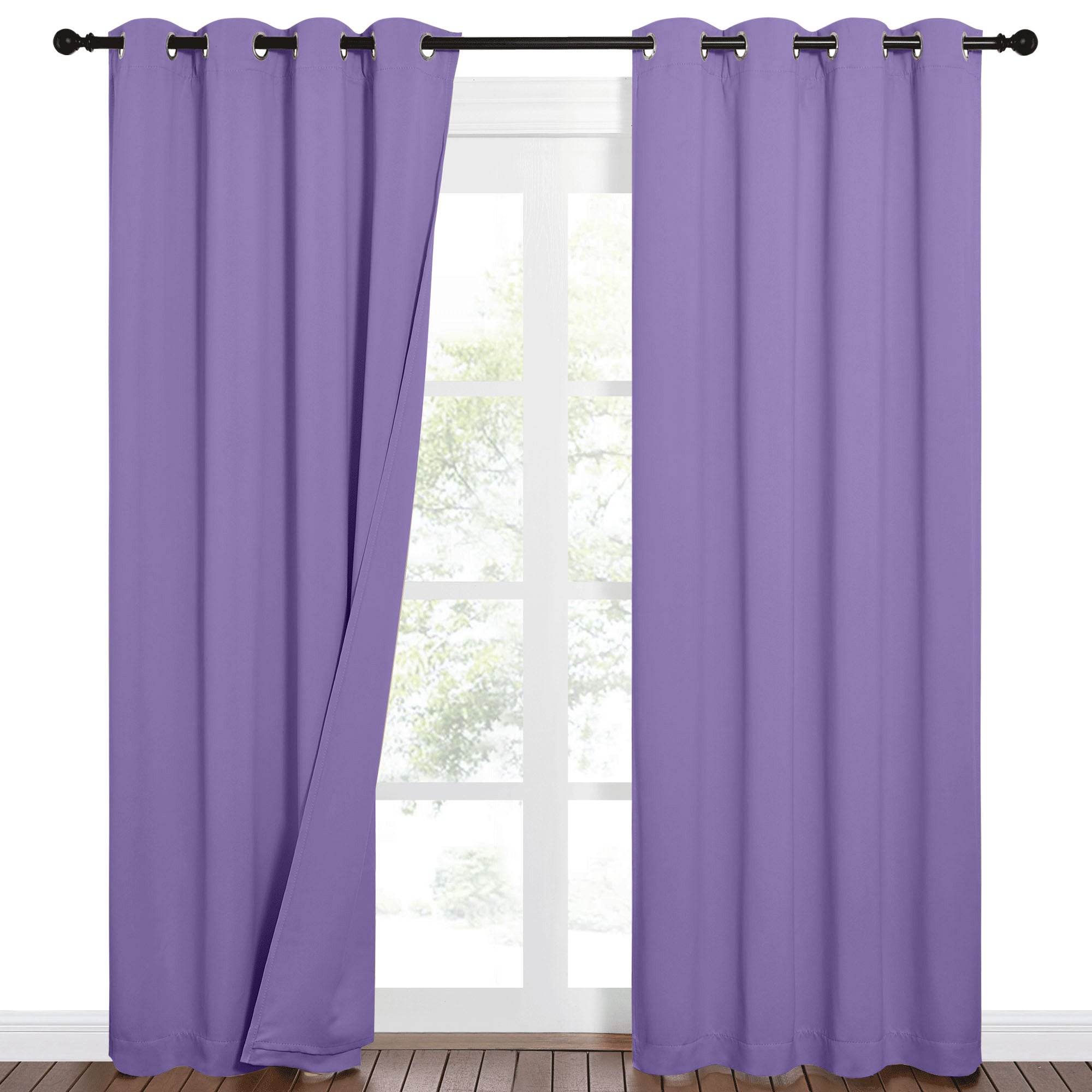 Purple grommet blackout curtains on a dark rod, one panel slightly open, revealing a bright window with outdoor trees.
