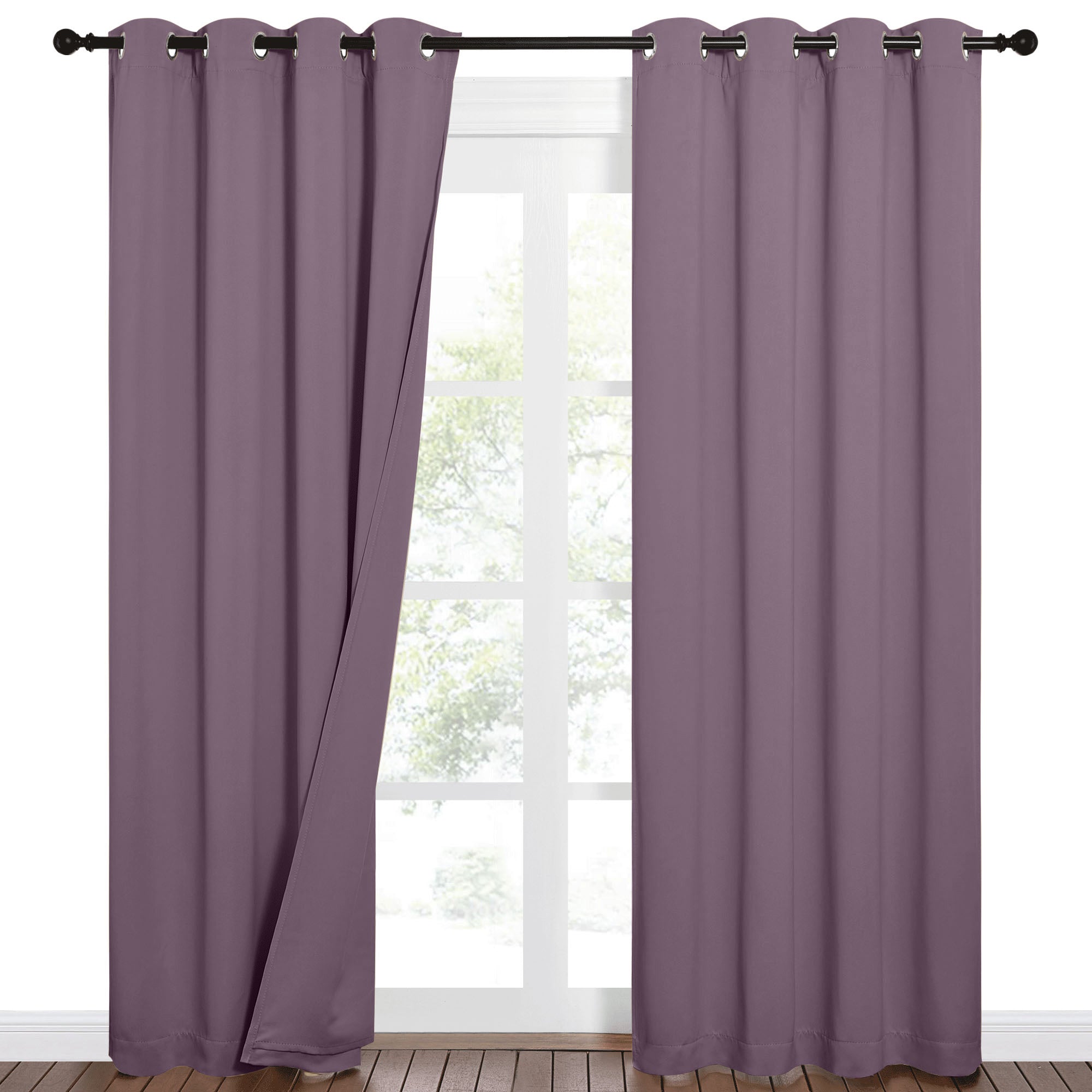 Plum purple blackout grommet curtains slightly open on a window, showing the sound barrier fabric and elegant drape.