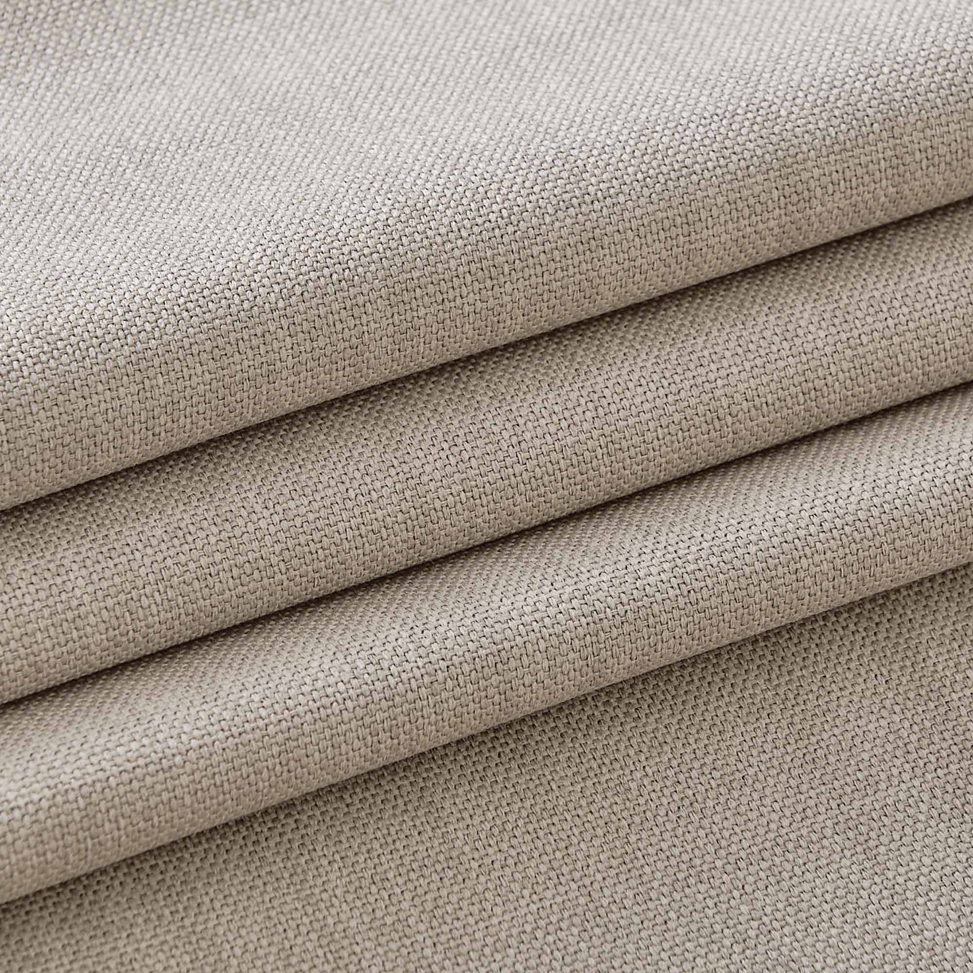 Detailed close-up of light beige tablecloth fabric, highlighting its durable woven texture and natural linen appearance.