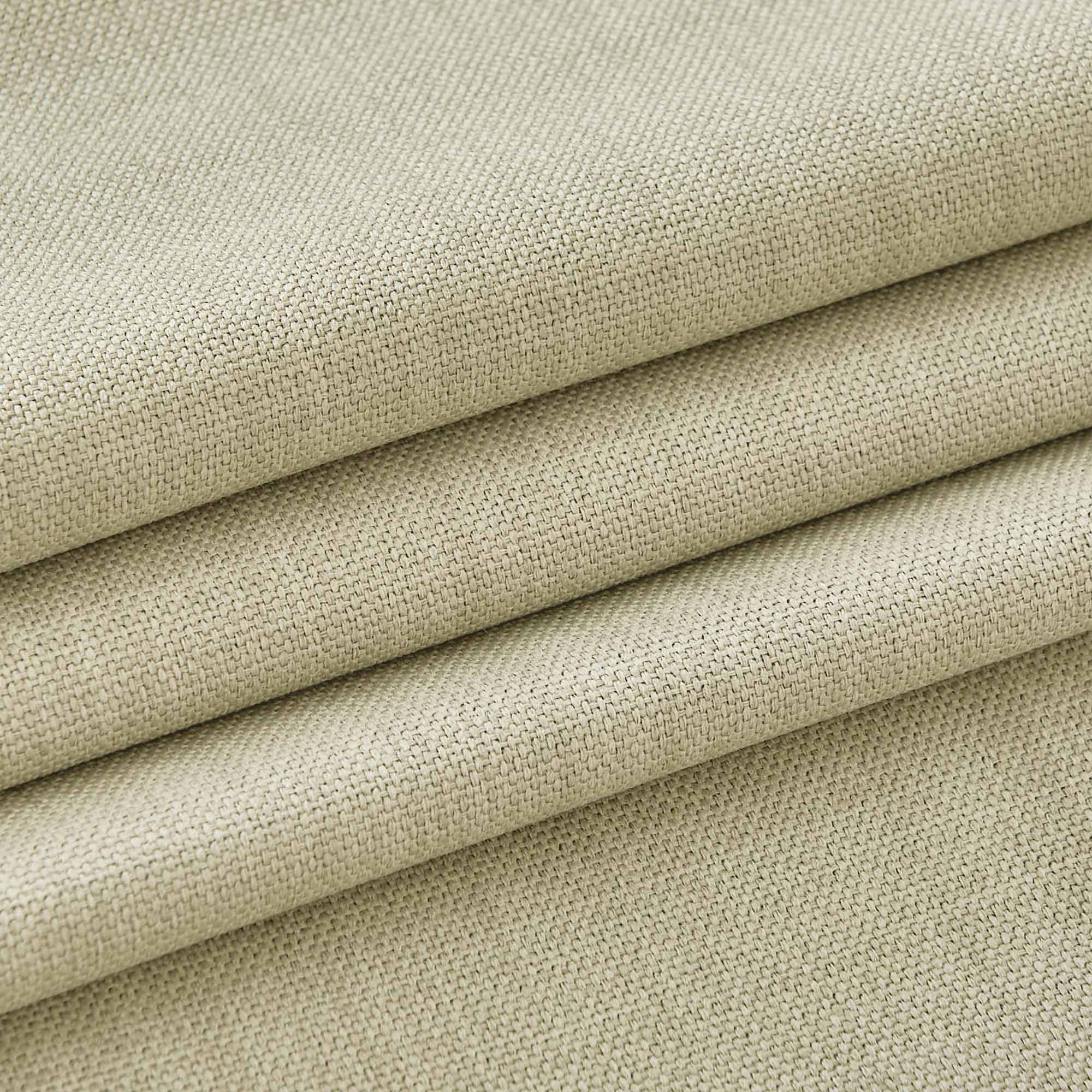 Close-up of folded light beige woven fabric, highlighting the detailed texture of the durable tablecloth material.