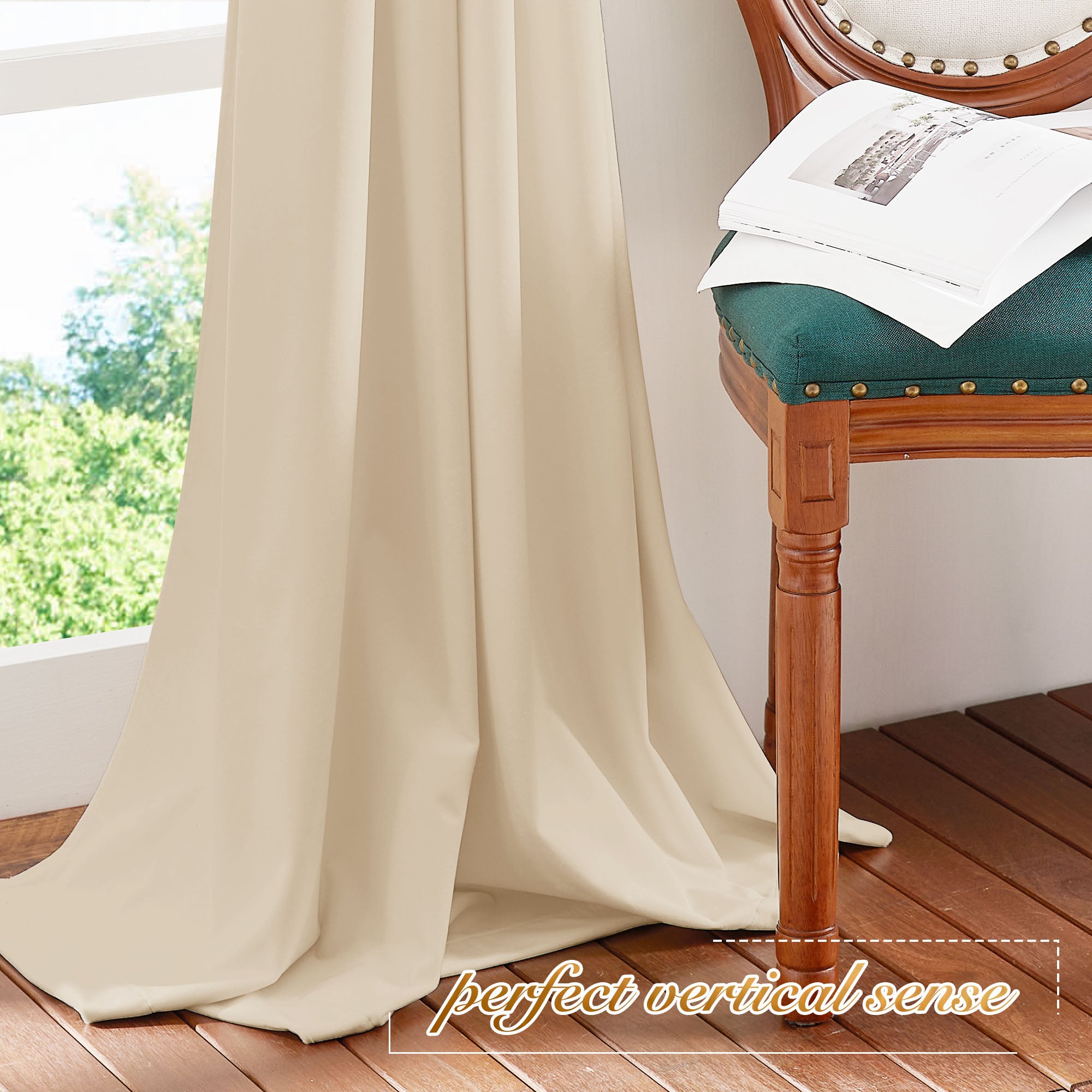 Beige velvet curtain panel showing the fabric's heavy vertical drape as it pools elegantly on a dark wood floor.