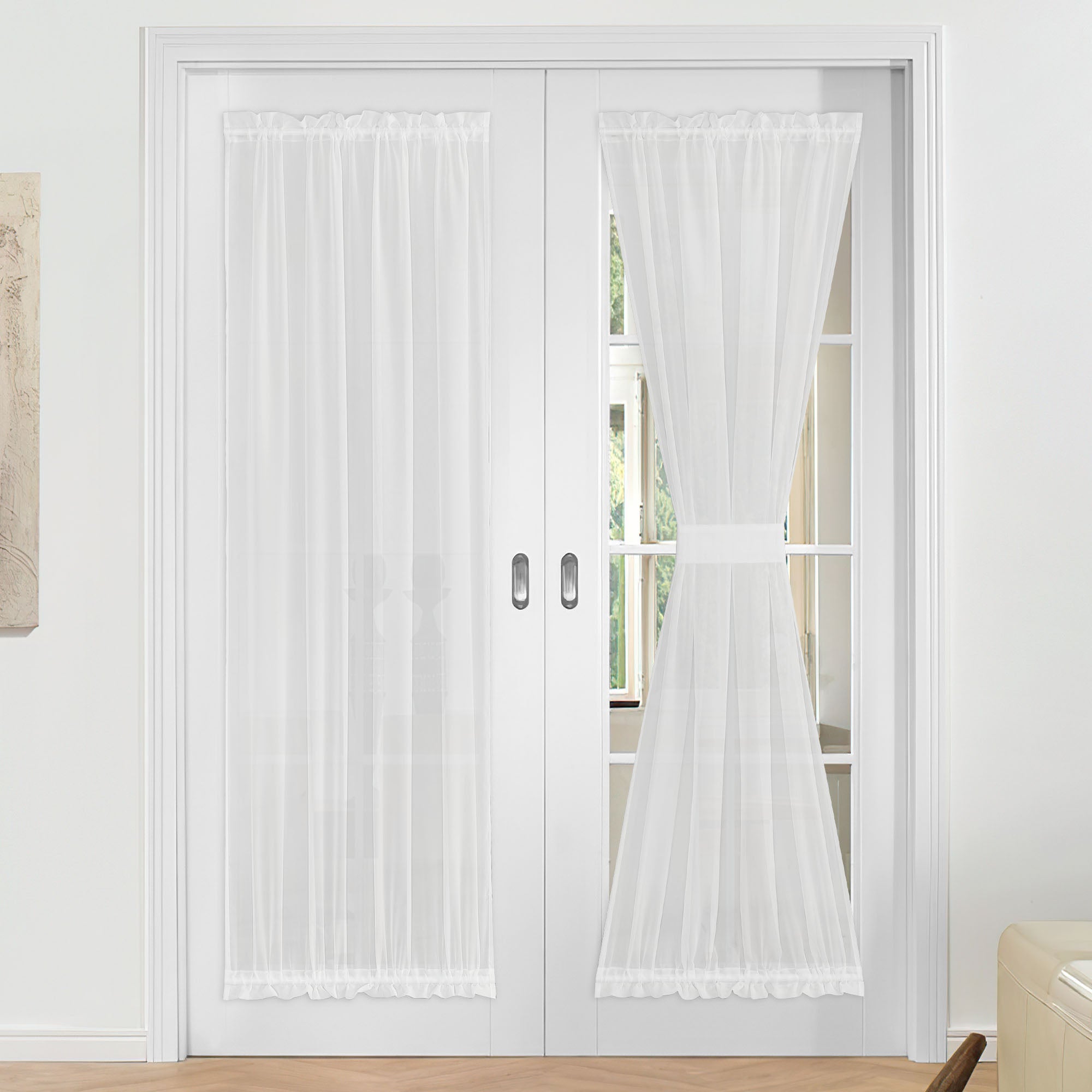 White voile sheer door curtains on French doors; one hangs freely, the other is tied back to demonstrate versatility.