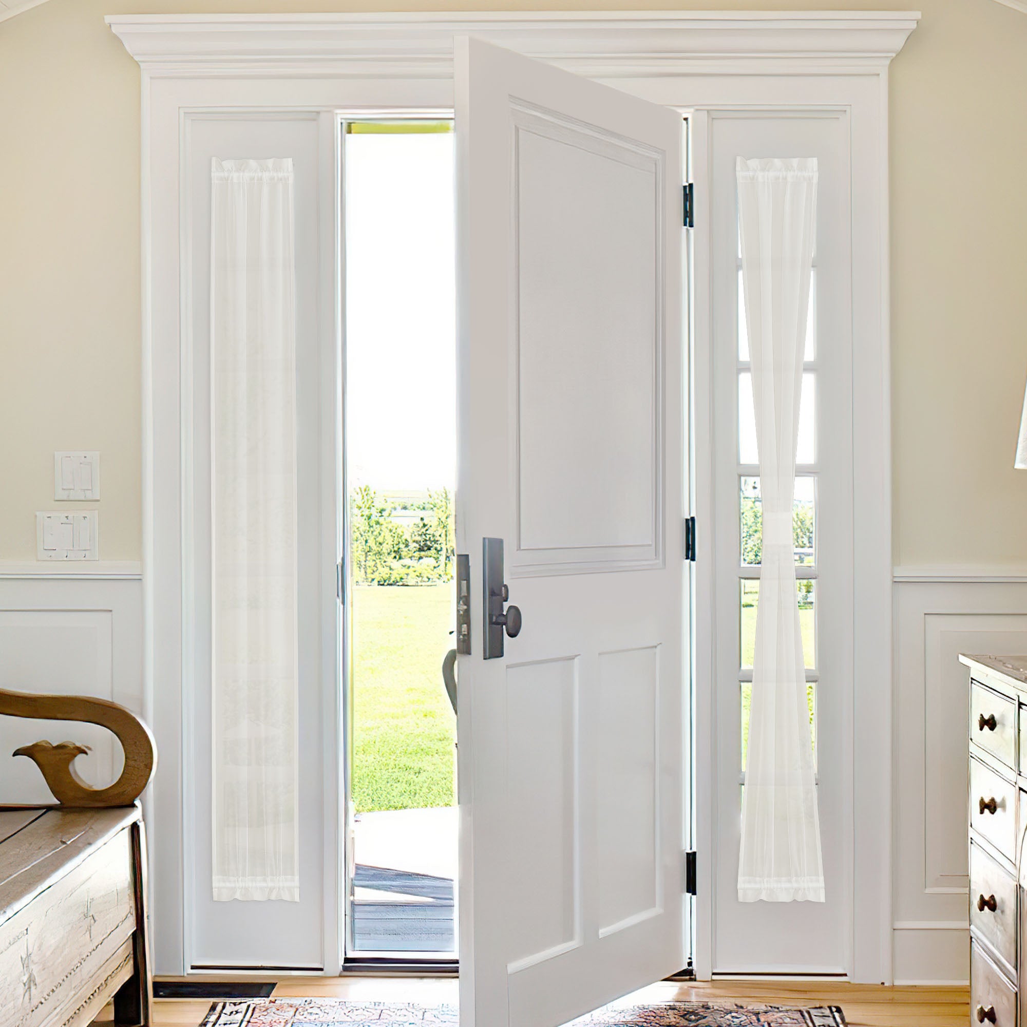 White sheer voile curtains on the glass panels of double French doors, one door slightly open revealing a sunny outdoor landscape.